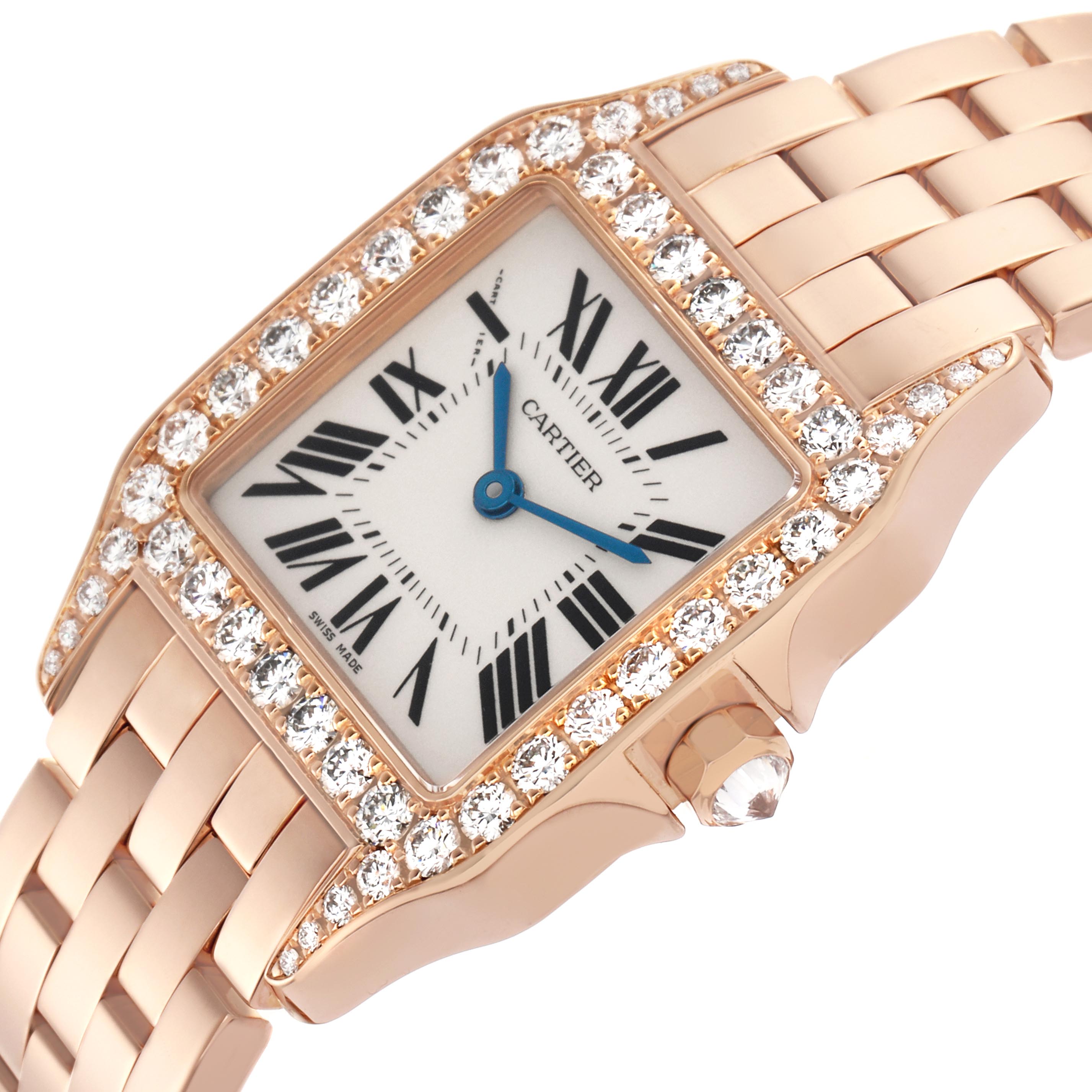 The Cartier Santos Demoiselle WF9007Z8 Women
s Rose Gold Silver Dial WF9007Z8 Women
s Rose Gold Silver Dial watch is shown at a tilted angle, highlighting the diamond-set bezel, case, dial, and metal bracelet.