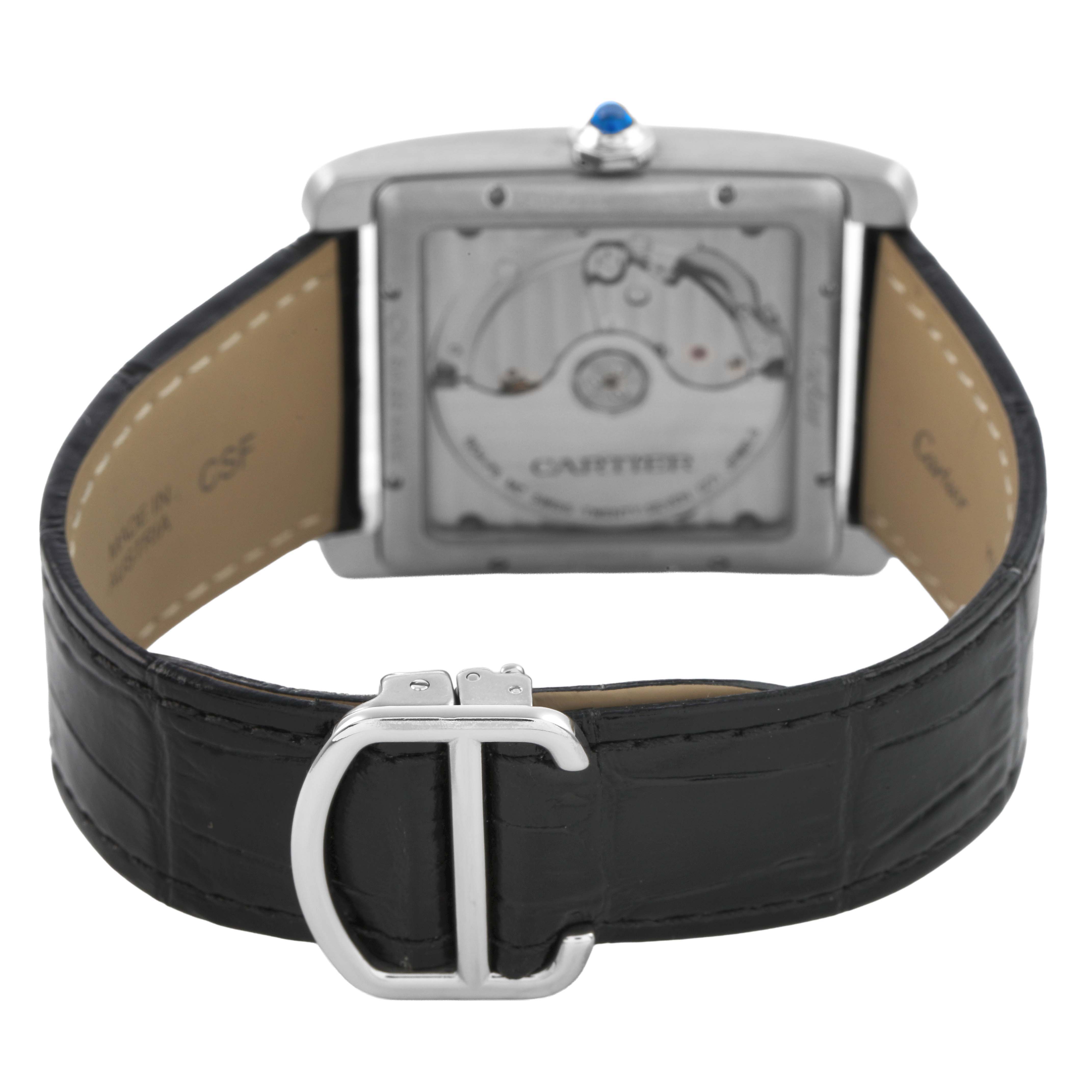 The image shows the back view of the Cartier Tank MC W5330004 Men's Stainless Steel Silver Dial watch, highlighting the movement and strap with a deployment clasp.