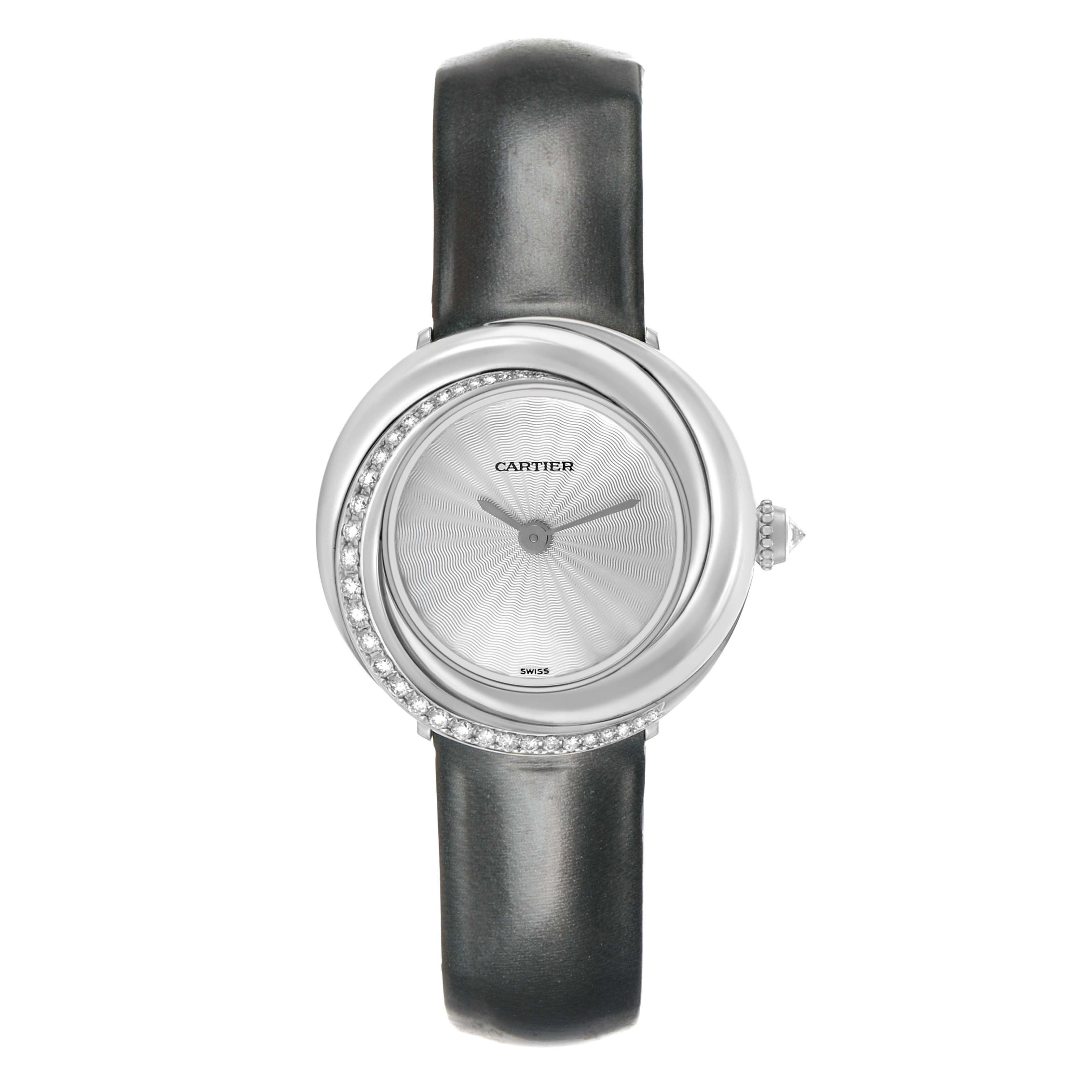 The Cartier Trinity WG201041 Women's White Gold Silver Dial watch is shown from a top-down angle, highlighting its round face, diamond-set bezel, and leather strap.