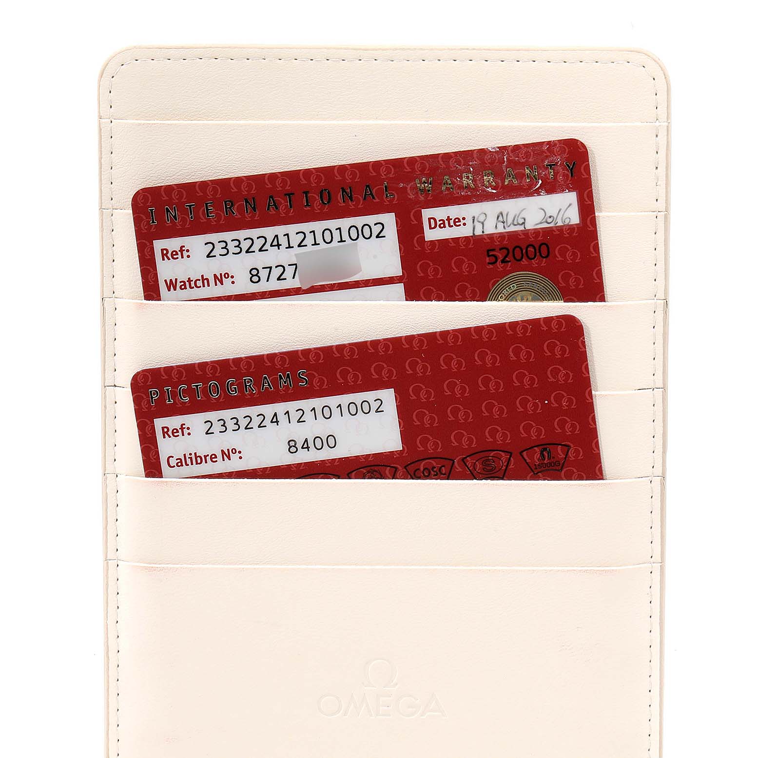 This image shows warranty and pictogram cards in a white Omega cardholder for the Seamaster model.