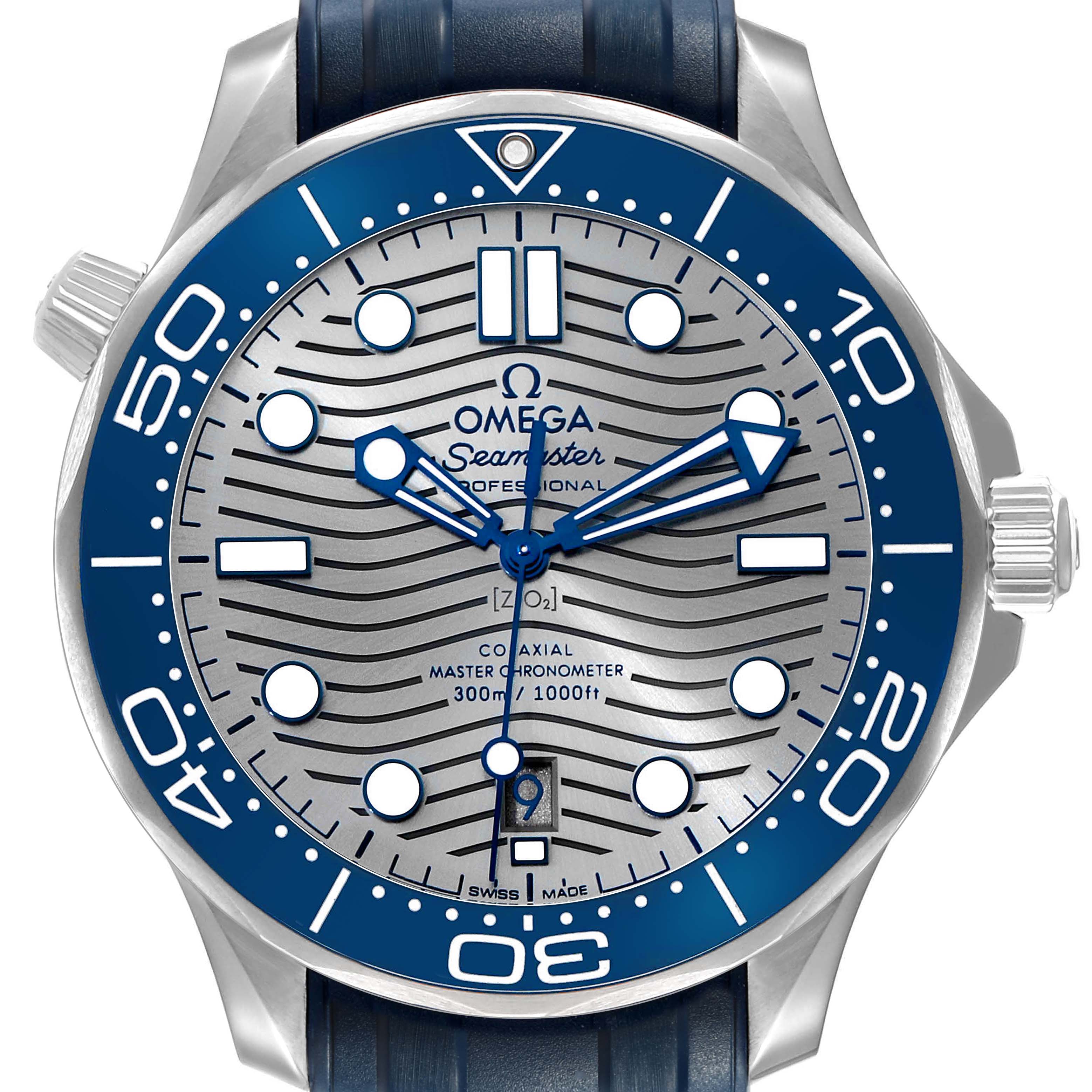 The Omega Seamaster 210.32.42.20.06.001 Men's Stainless Steel Grey Dial watch is shown from a front angle, highlighting its blue bezel, silver wave-patterned dial, and date display.