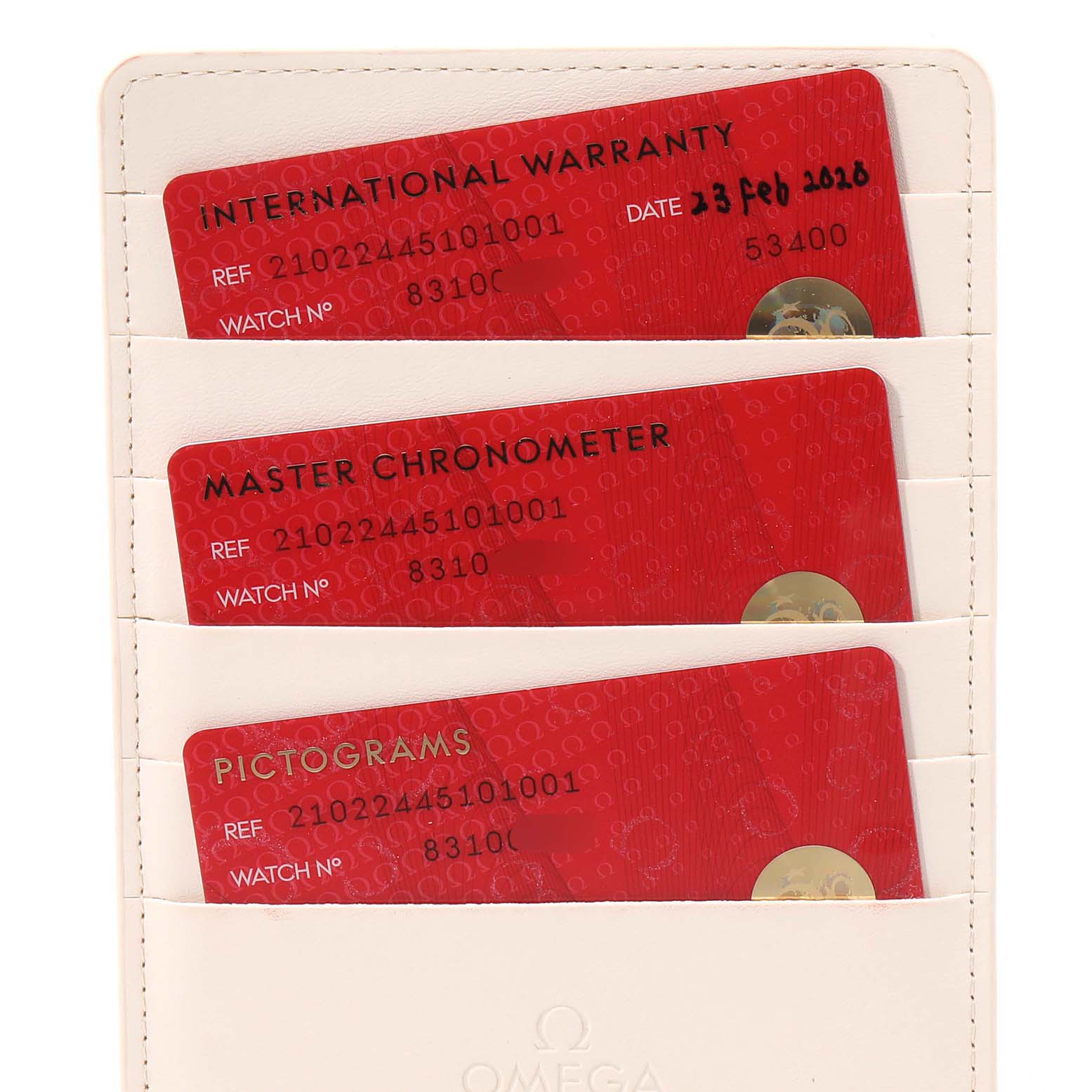 This image shows the warranty, master chronometer, and pictogram cards for the Omega Seamaster 210.22.44.51.01.001 Men's Steel and Gold (two tone) Black Dial 210.22.44.51.01.001 Men's Steel and Gold (two tone) Black Dial watch.