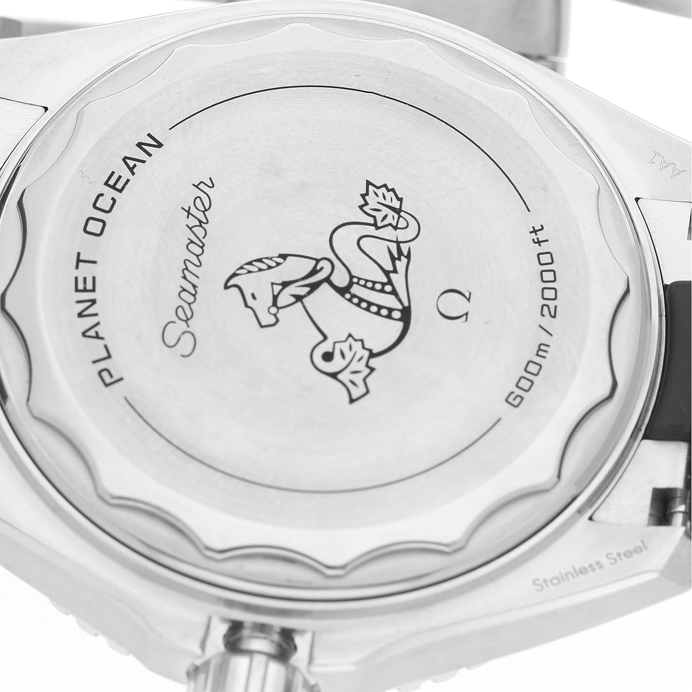 The image shows the case back of the Omega Planet Ocean 217.32.42.21.01.001 Men's Stainless Steel Black Dial Seamaster, featuring engravings and the brand's emblem.