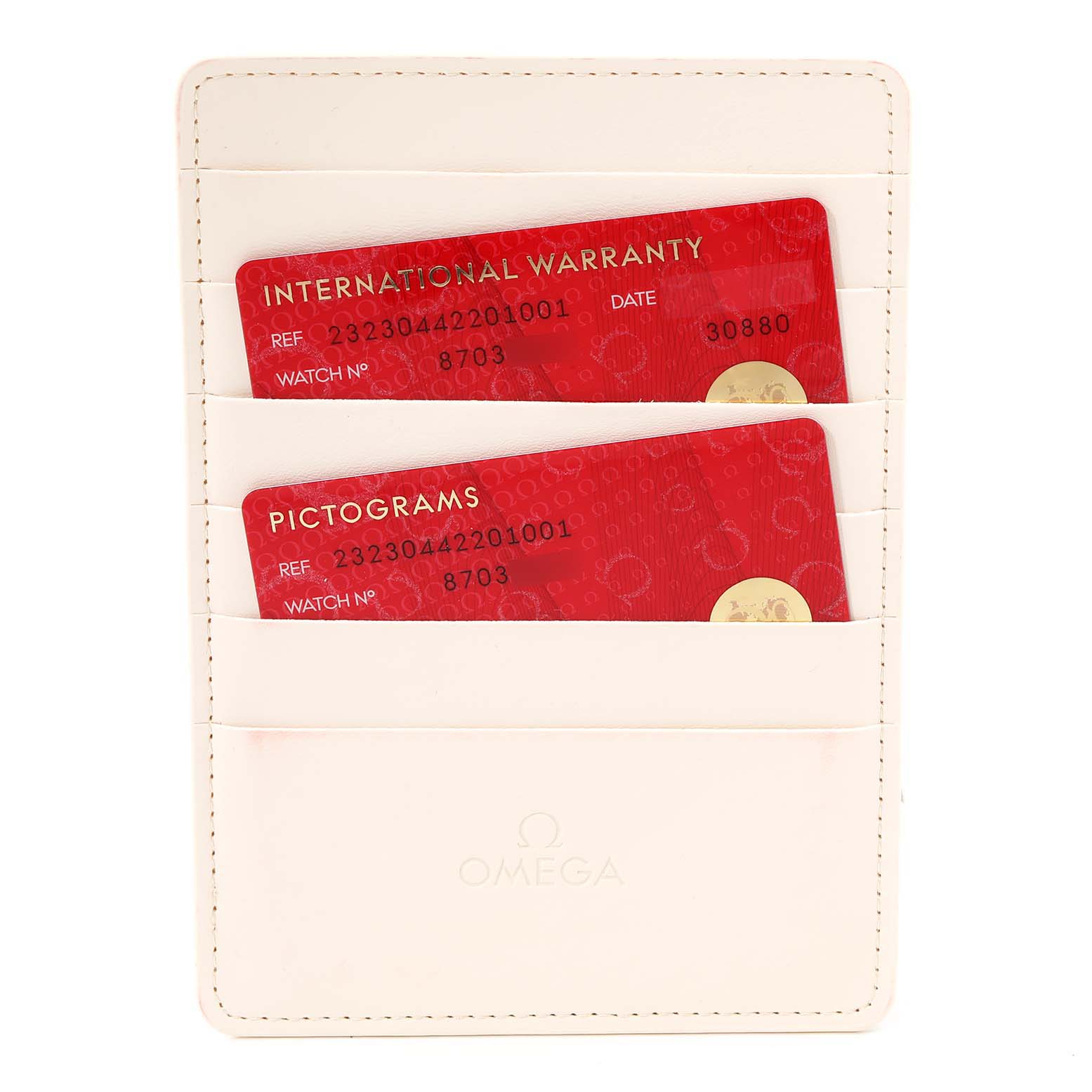 The image shows a white cardholder with Omega branding, containing international warranty and pictogram cards for an Omega Seamaster 232.30.44.22.01.001 Men's Steel and Gold (two tone) Black Dial 232.30.44.22.01.001 Men's Steel and Gold (two tone) Black Dial watch.