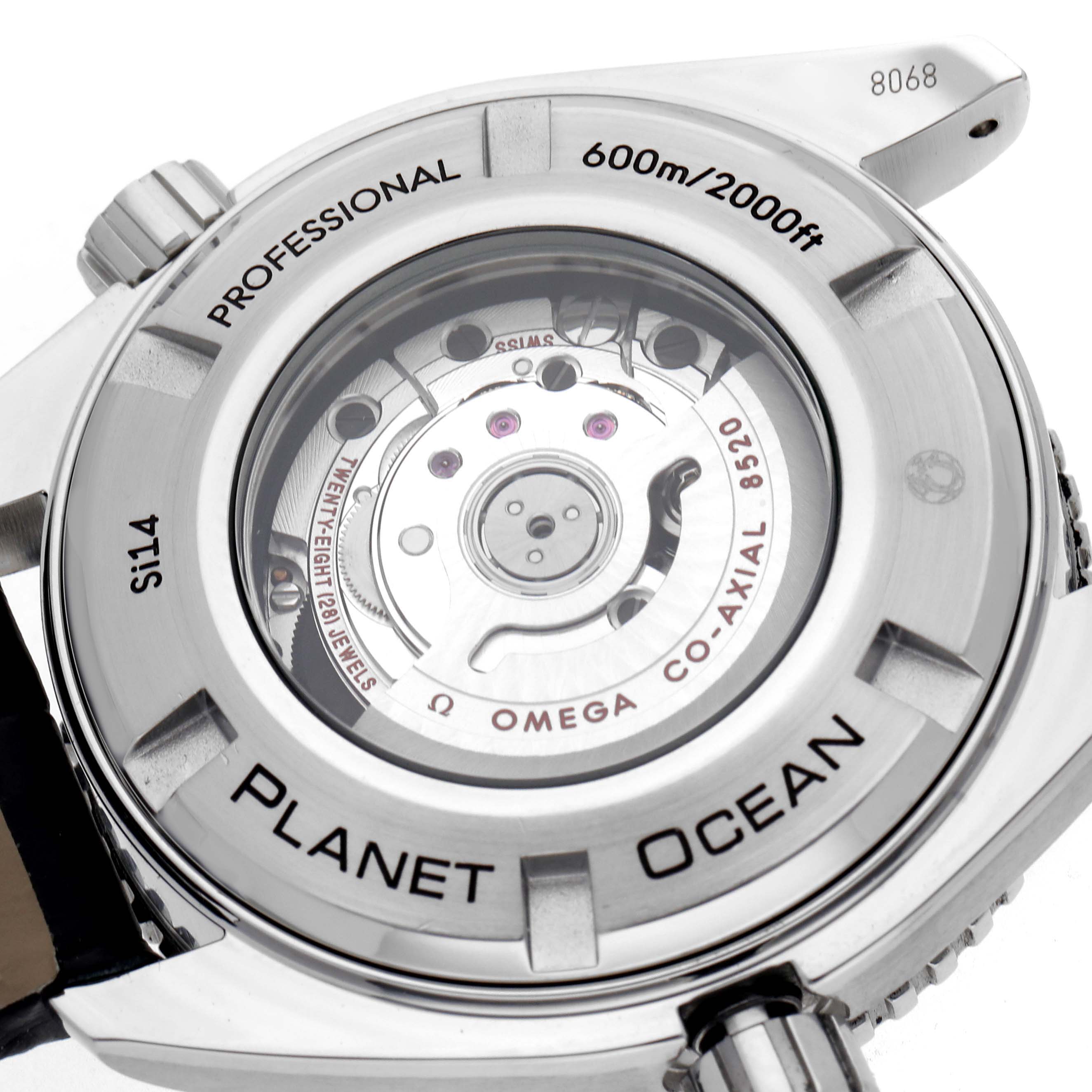 The image shows the back of an Omega Planet Ocean 232.33.38.20.01.002 Men
s Stainless Steel Black Dial 232.33.38.20.01.002 Men
s Stainless Steel Black Dial watch, highlighting the movement and engravings.