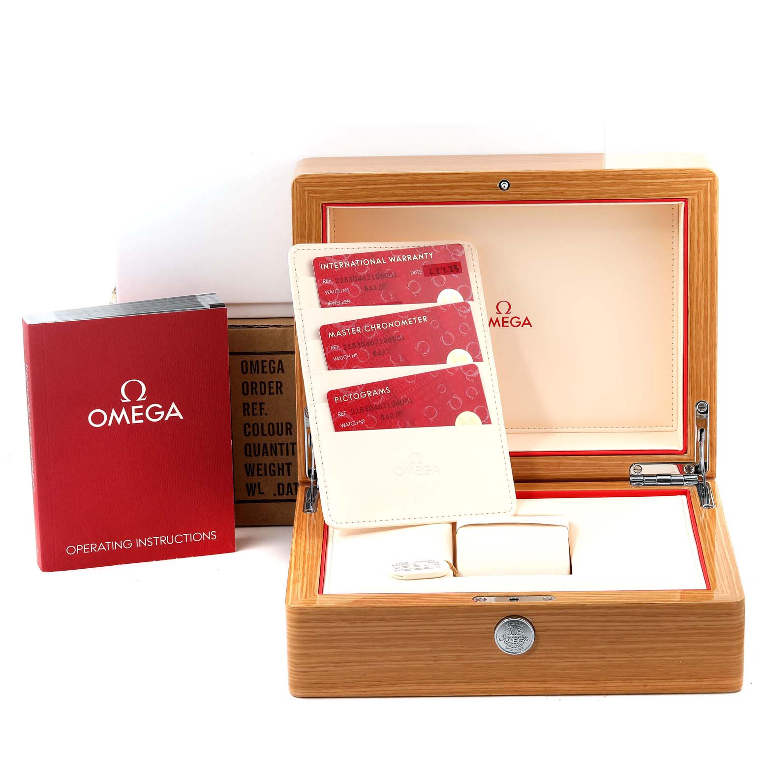 The image shows the open box, warranty cards, and instruction manual for the Omega Planet Ocean 215.30.46.21.06.001 Men's Stainless Steel Grey Dial 215.30.46.21.06.001 Men's Stainless Steel Grey Dial watch.