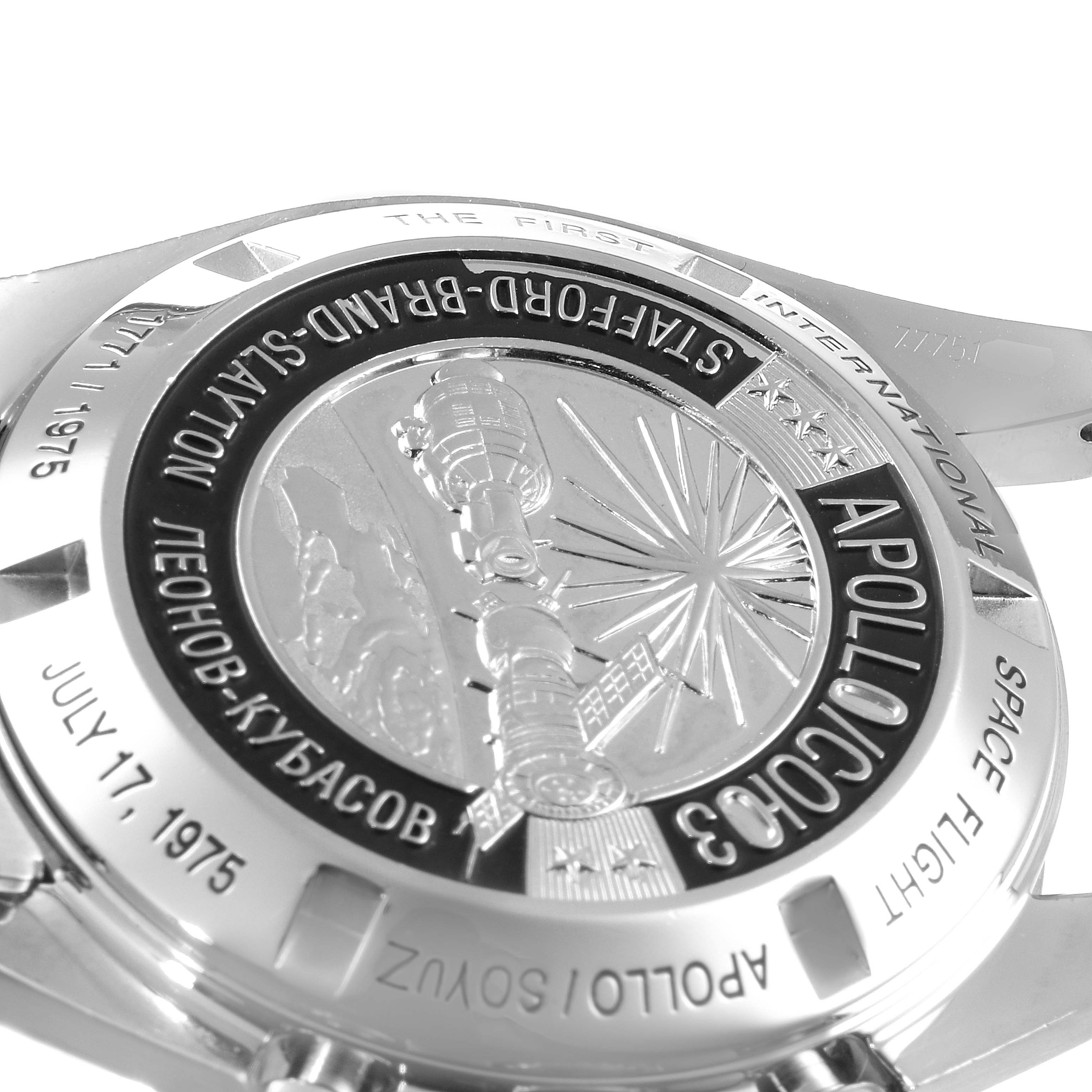 The image shows the back of an Omega Speedmaster 311.30.42.30.99.001 Men
s Stainless Steel Silver Dial 311.30.42.30.99.001 Men
s Stainless Steel Silver Dial watch, featuring an engraved Apollo-Soyuz mission emblem.