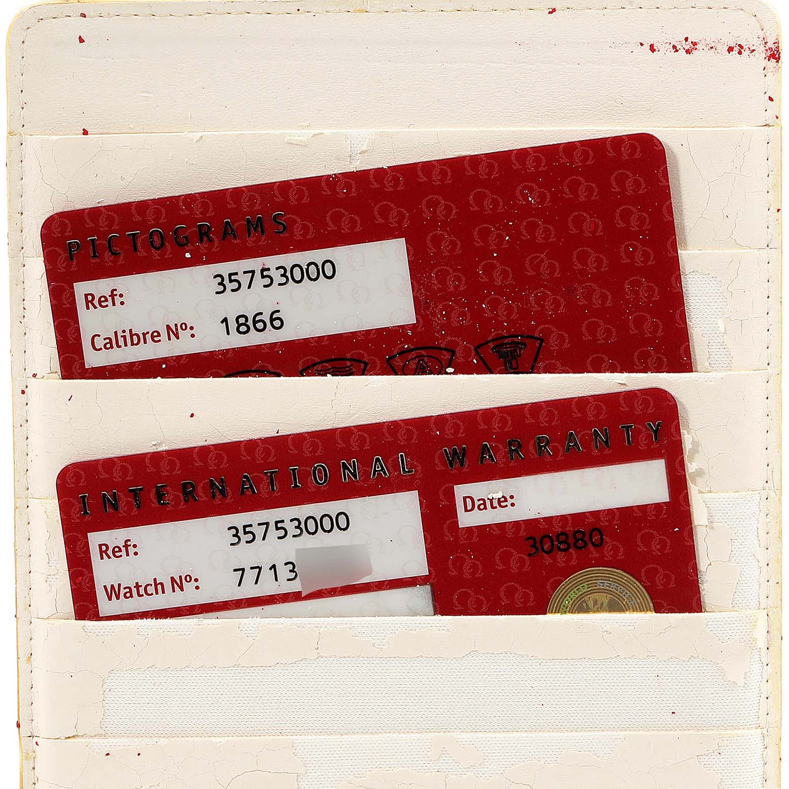 The image shows warranty and pictogram cards for an Omega Speedmaster 3575.30.00 Men
s Stainless Steel Silver Dial 3575.30.00 Men
s Stainless Steel Silver Dial watch, displayed partially inside a cardholder.