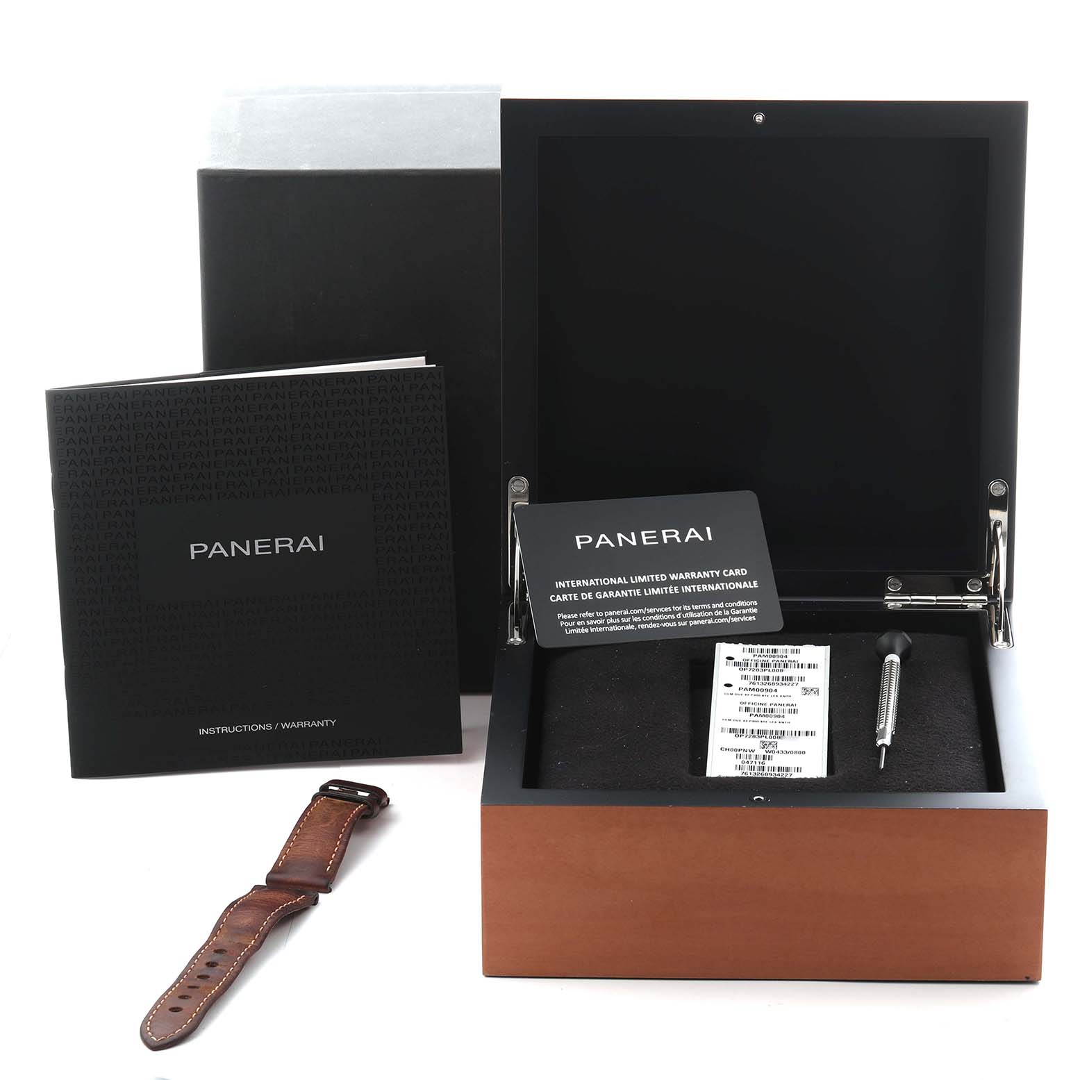 The image shows a Panerai Luminor Due PAM00904 Men
s Stainless Steel Grey Dial PAM00904 Men
s Stainless Steel Grey Dial watch box, instruction booklet, warranty card, strap, and tool from a top-down angle.