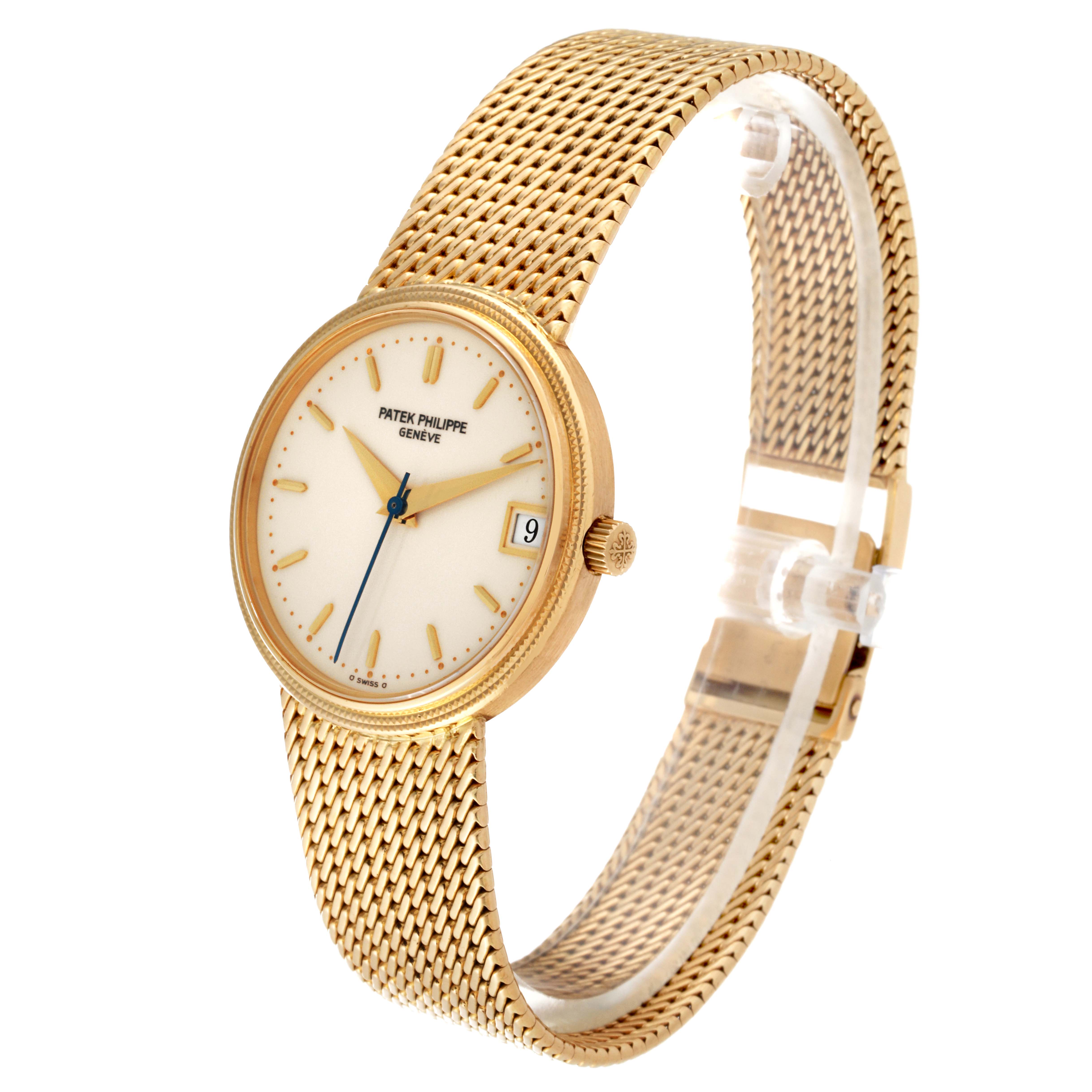 The Patek Philippe Calatrava 3802 Men
s Yellow Gold White Dial 3802 Men
s Yellow Gold White Dial watch is shown at a three-quarter angle, displaying its gold mesh bracelet, ivory dial, and date window.