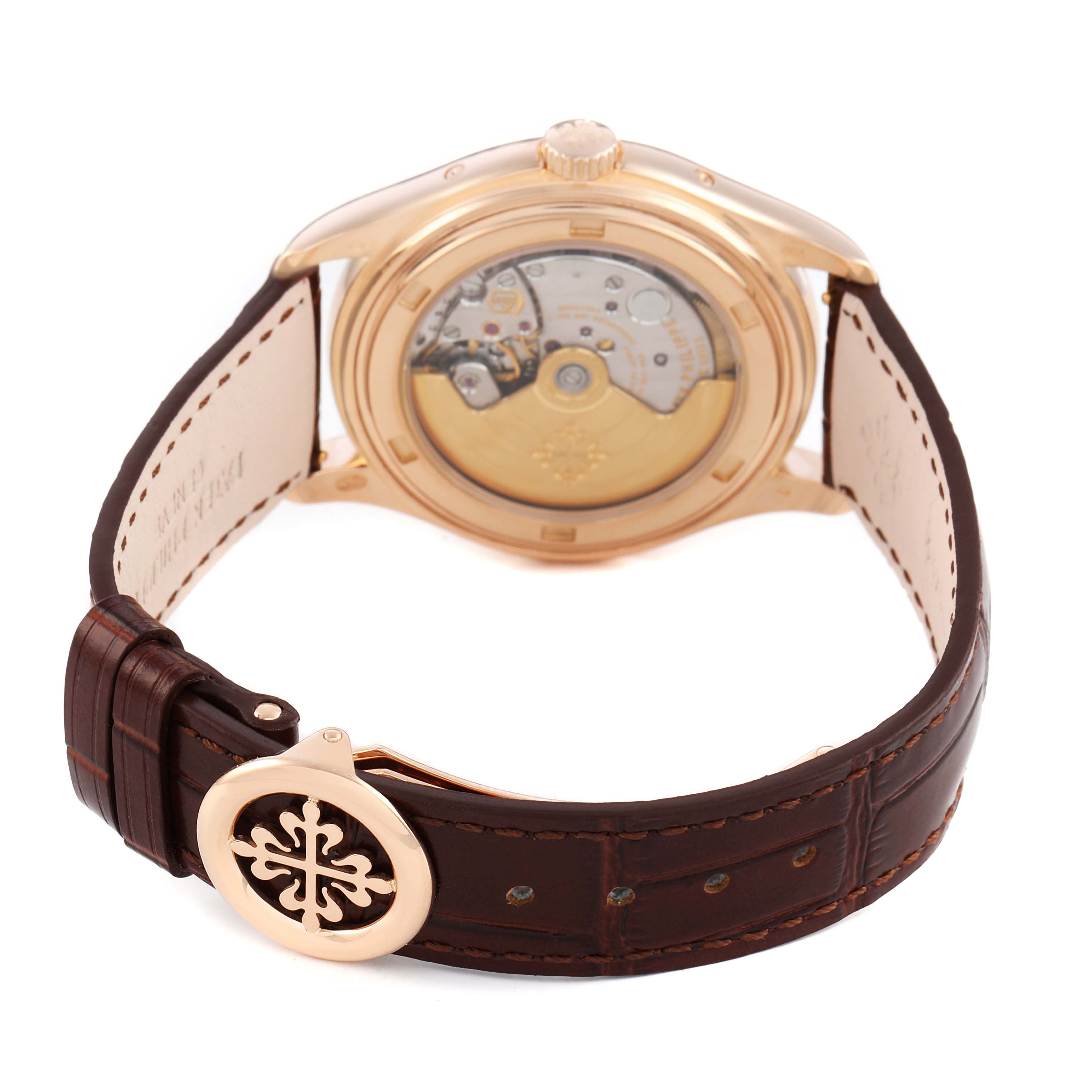The Patek Philippe Complications 5146R-001 Men's Rose Gold White Dial watch is shown from a rear angle, highlighting the movement and leather strap with emblem.