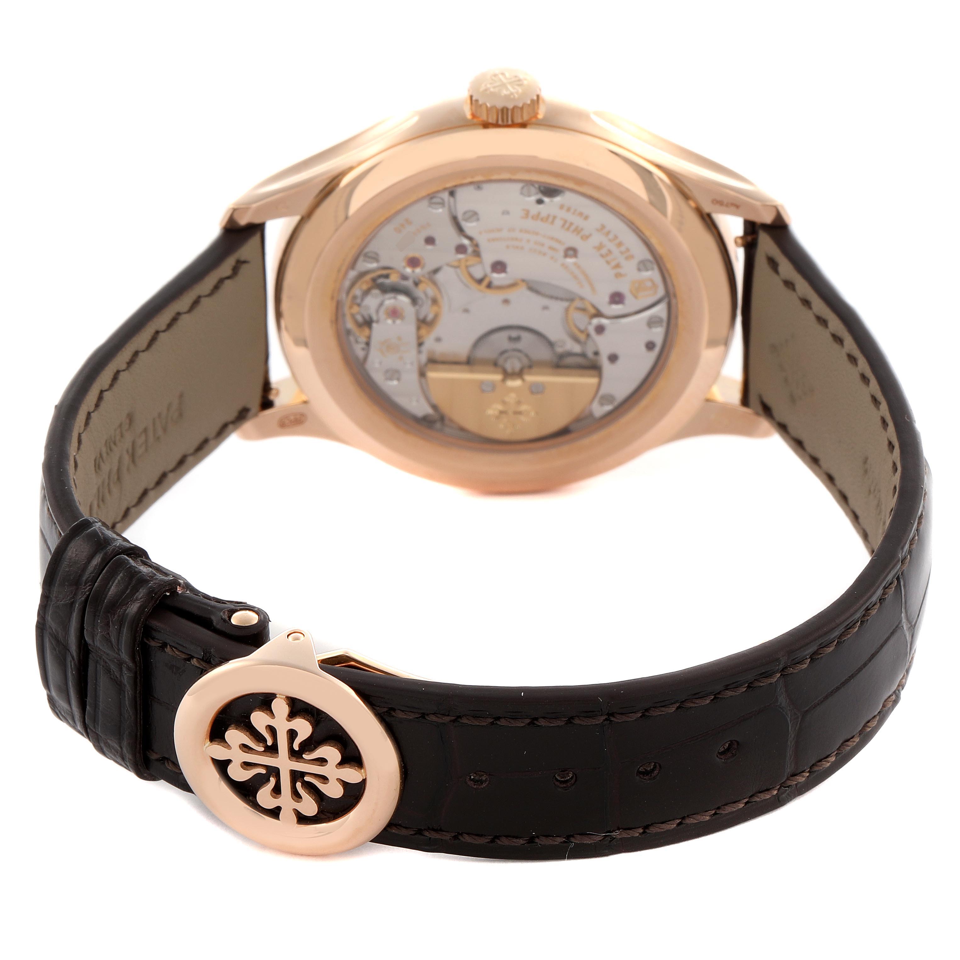 The Patek Philippe Complications 5327R Men
s Rose Gold Beige Dial 5327R Men
s Rose Gold Beige Dial model is shown from the back, highlighting the movement and leather strap with buckle.