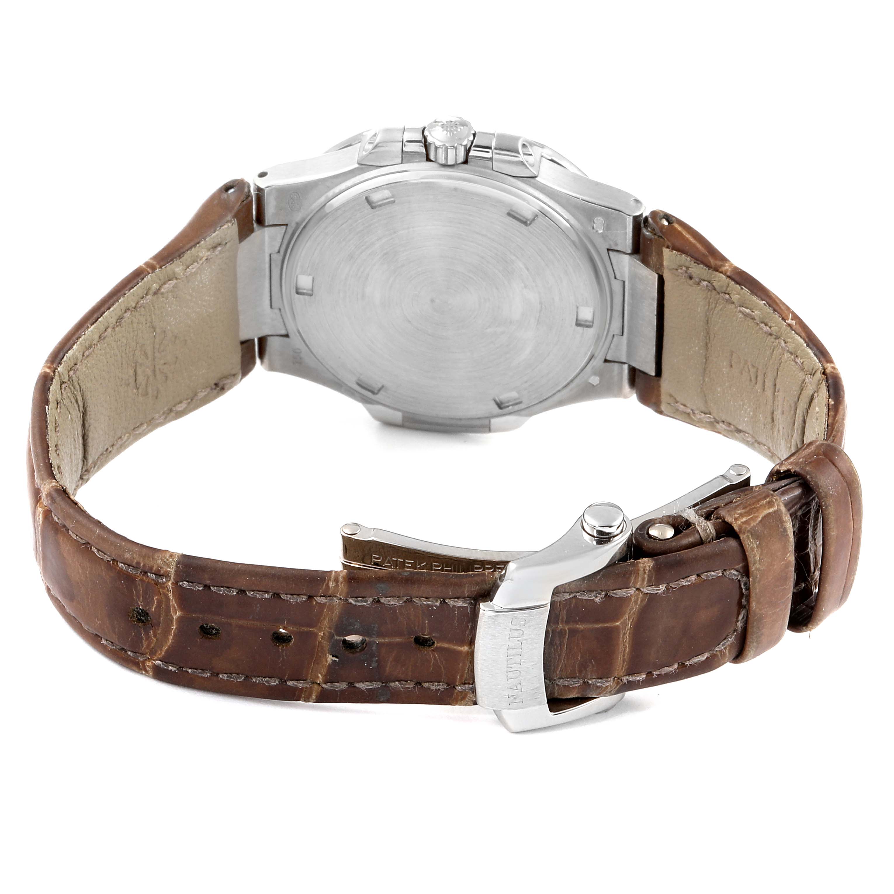 The image shows the back view of a Patek Philippe Nautilus 7010G Women's White Gold Grey Dial 7010G Women's White Gold Grey Dial watch, highlighting its case back and leather strap with a buckle.