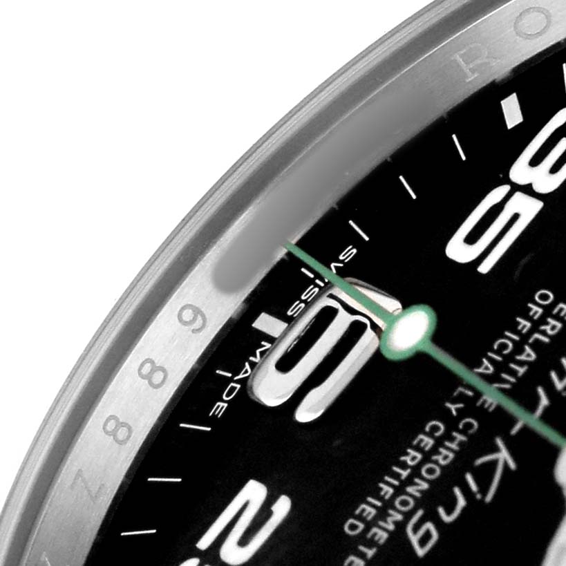 The image shows a close-up of the dial and bezel of the Rolex Air-King 116900 Men's Stainless Steel Black Dial watch, highlighting numbers and text.