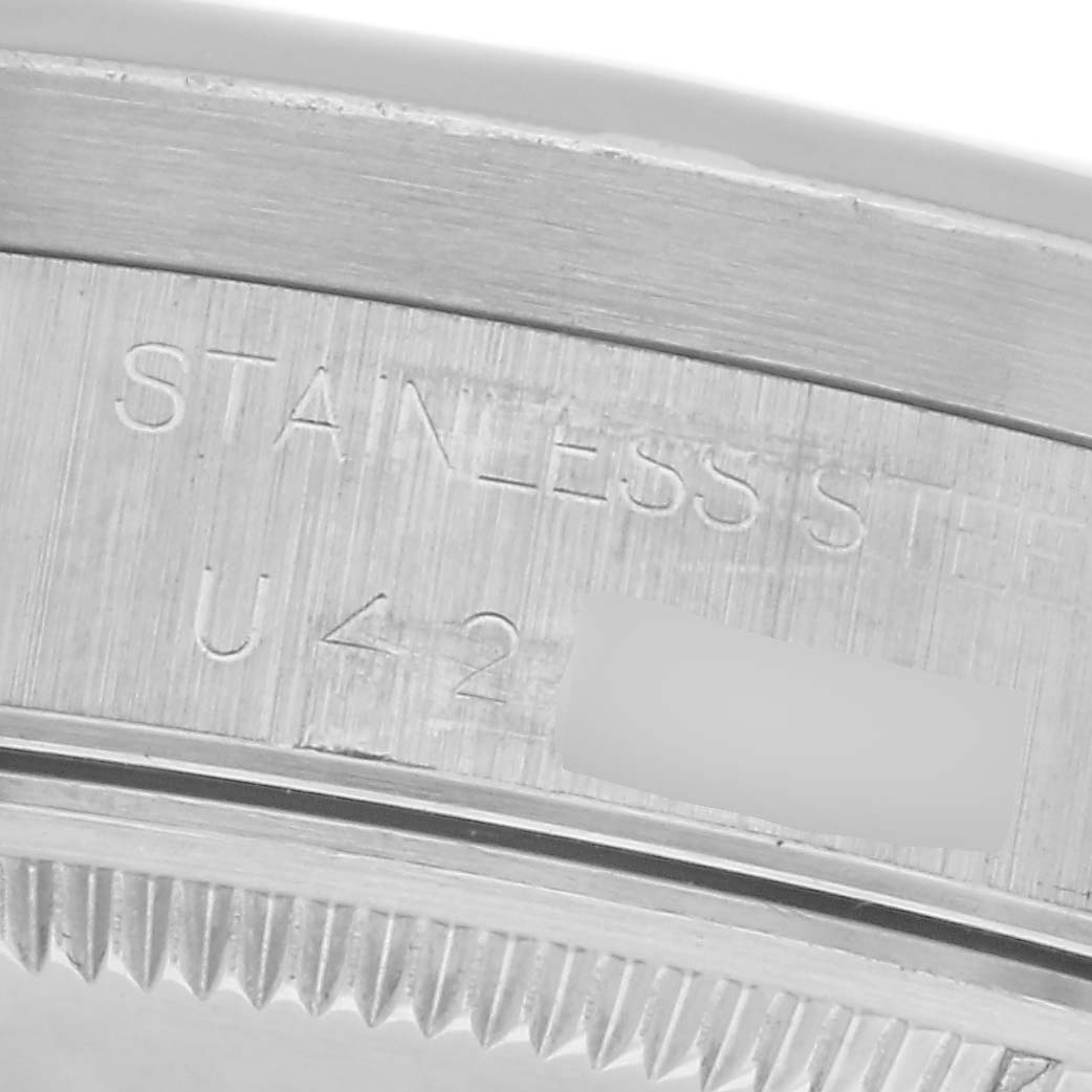 The image shows a close-up of the engraved caseback edge of a Rolex Air-King 14010 Men's Stainless Steel Blue Dial 14010 Men's Stainless Steel Blue Dial watch, highlighting "STAINLESS STEEL" and numbers.