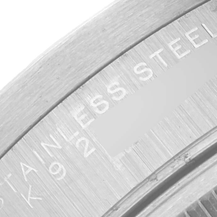 This close-up image shows the engraved text on the stainless steel casing of a Rolex Date 15210 Men's Stainless Steel Black Dial 15210 Men's Stainless Steel Black Dial model watch.