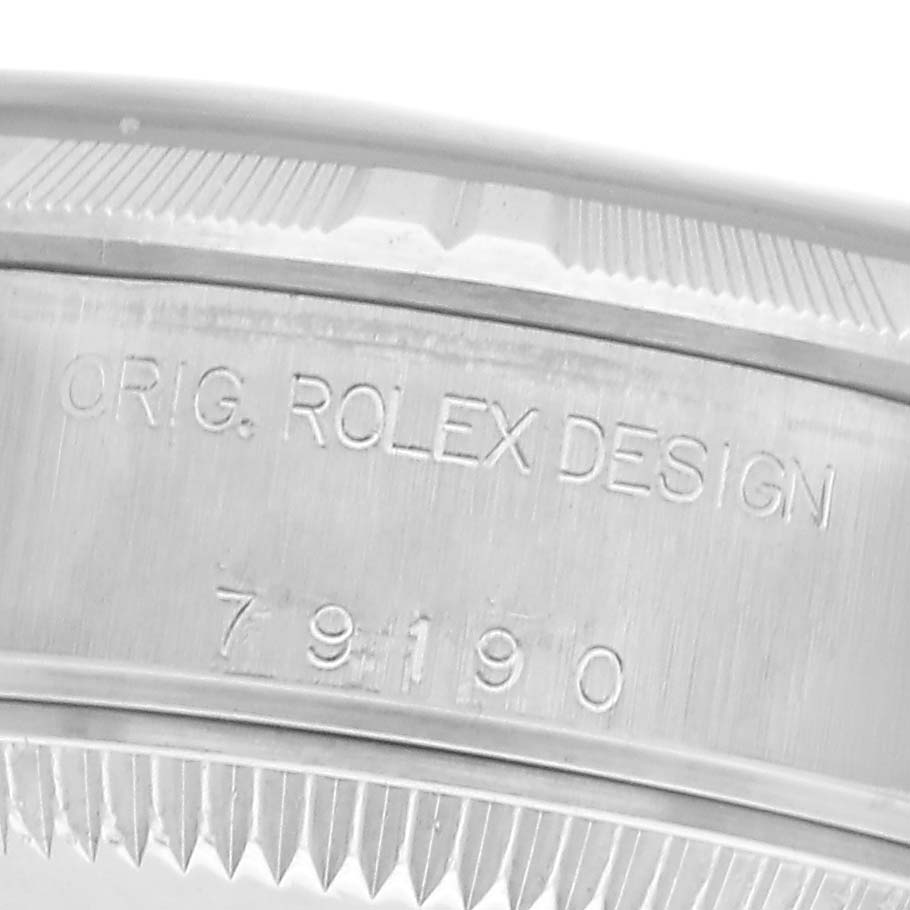 The image shows the side engraving of a Rolex Date 79190 Women
s Stainless Steel Silver Dial 79190 Women
s Stainless Steel Silver Dial model, featuring serial and design numbers.