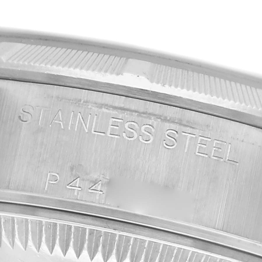 The image shows a close-up of the Rolex Date 79190 Women
s Stainless Steel Silver Dial 79190 Women
s Stainless Steel Silver Dial model
s stainless steel case back with engraved text.
