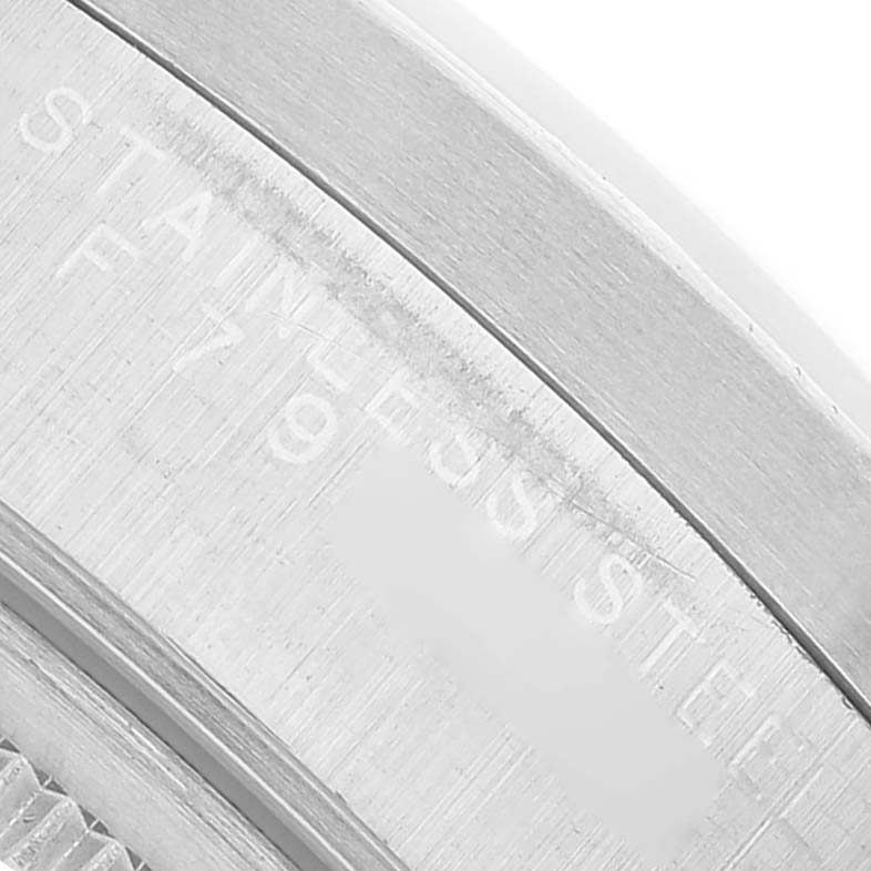 The image shows a close-up of the case side of the Rolex Date 15210 Men's Stainless Steel Silver Dial, highlighting the "Stainless Steel" engraving.