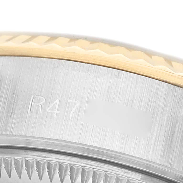 The image shows a close-up of the fluted bezel and part of the case of a Rolex Datejust 69173 Women's Steel and Gold (two tone) Blue Dial watch.