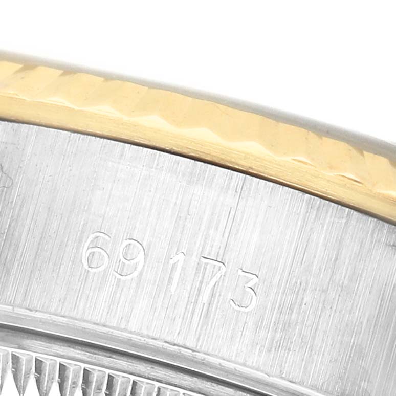 The image shows a close-up of the case side with engraved model number and part of the bezel of the Rolex Datejust 69173 Women's Steel and Gold (two tone) Blue Dial.