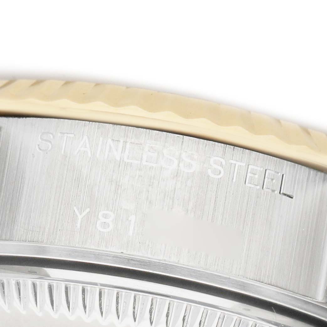 The image shows a close-up of the side view of a Rolex Datejust 79173 Women's Stainless Steel Champagne Dial watch case, highlighting the fluted bezel and stainless steel engraving.