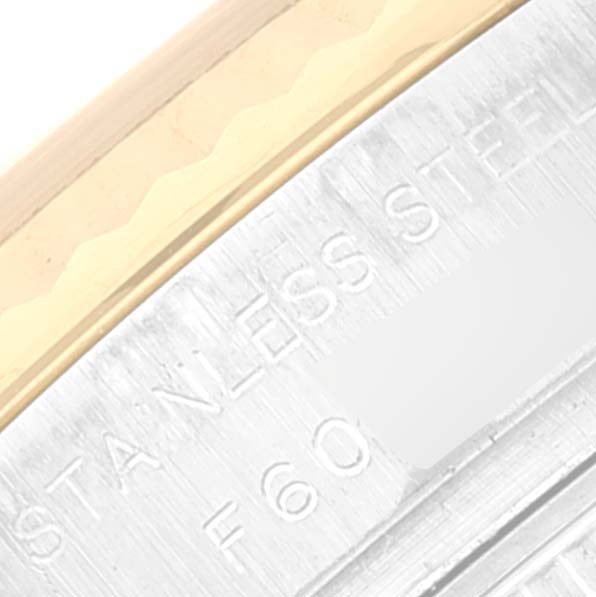 The image shows a close-up angle of the stainless steel case side of a Rolex Datejust 179173 Women's Steel and Gold (two tone) Champagne Dial 179173 Women's Steel and Gold (two tone) Champagne Dial watch, partially revealing "Stainless Steel" engraving.