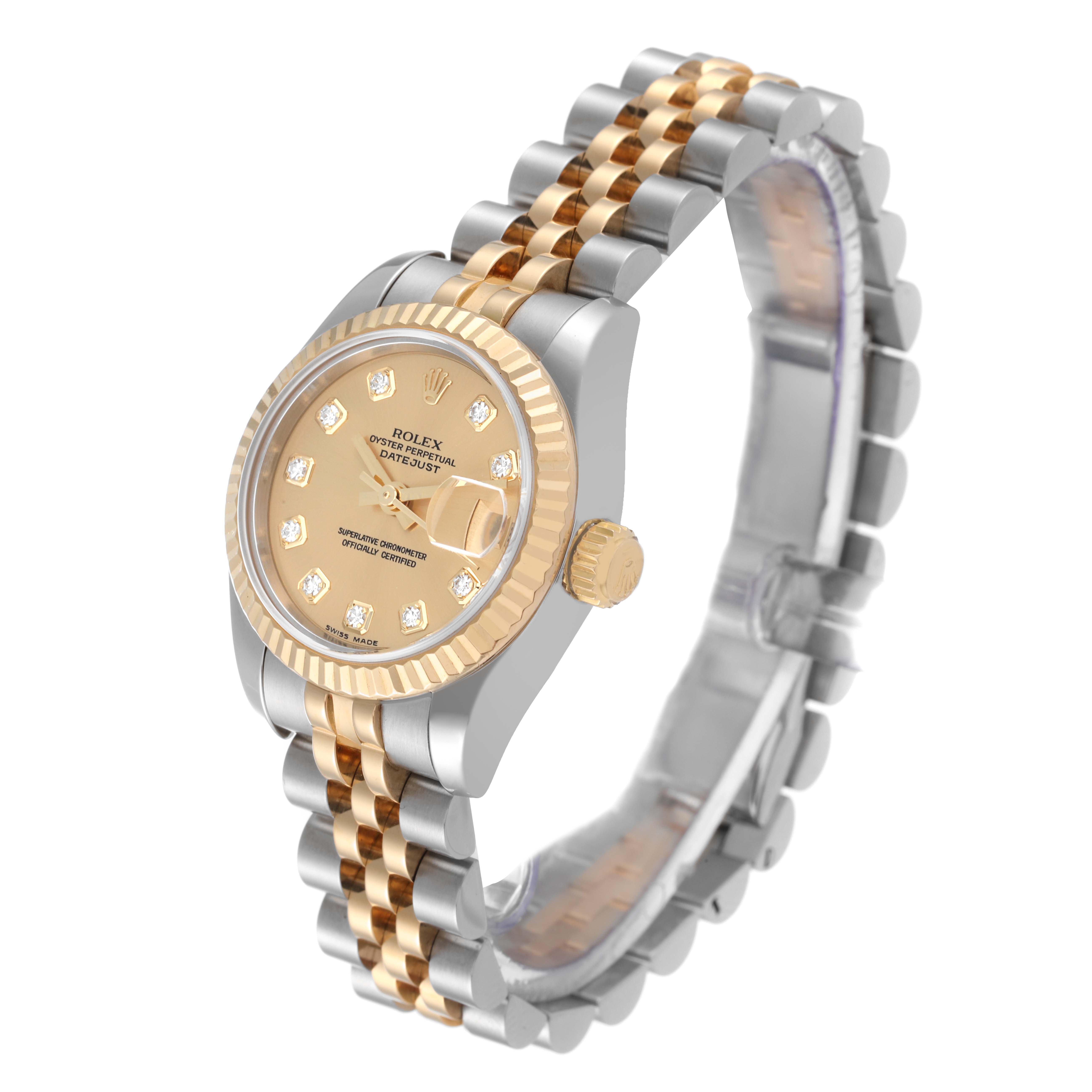 The image shows a Rolex Datejust 179173 Women's Steel and Gold (two tone) Champagne Dial 179173 Women's Steel and Gold (two tone) Champagne Dial watch from a three-quarter angle, highlighting its two-tone bracelet, gold bezel, and champagne diamond dial.