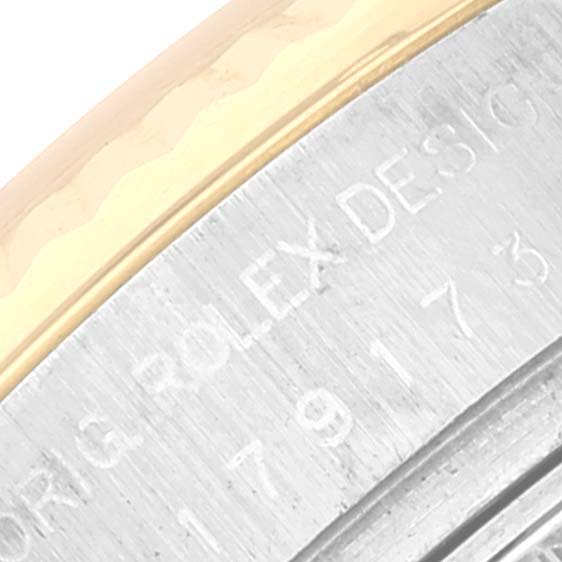 The image shows a close-up of the side of a Rolex Datejust 179173 Women's Steel and Gold (two tone) Champagne Dial 179173 Women's Steel and Gold (two tone) Champagne Dial watch, highlighting the engraved text and two-tone metal design.