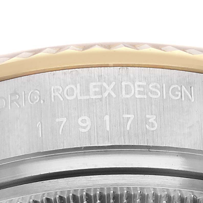 This image shows a close-up of the side engraving on the case of a Rolex Datejust 179173 Women's Steel and Gold (two tone) Champagne Dial 179173 Women's Steel and Gold (two tone) Champagne Dial watch, displaying the model number.