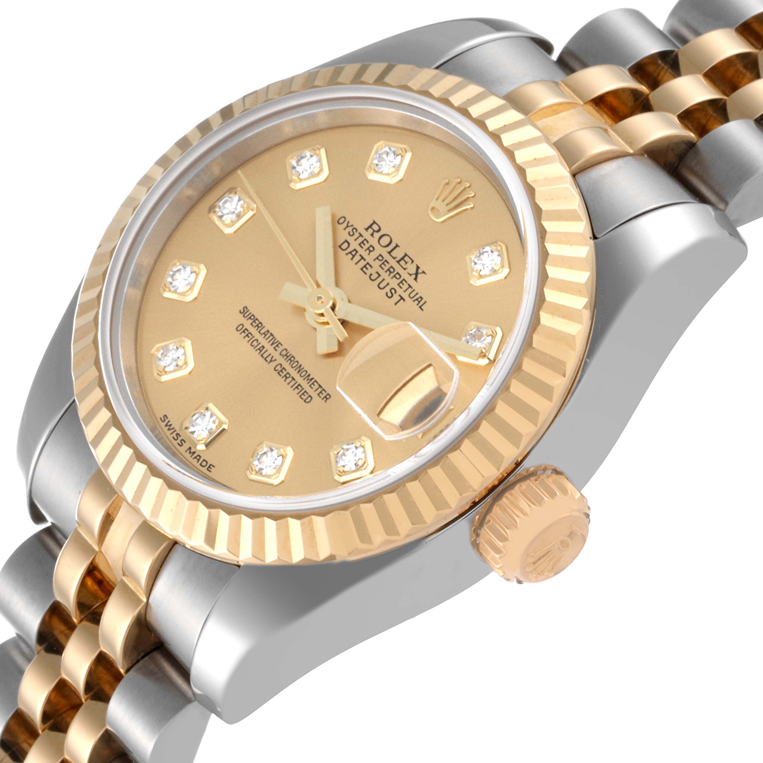 This image shows a close-up angle of a Rolex Datejust 179173 Women's Steel and Gold (two tone) Champagne Dial 179173 Women's Steel and Gold (two tone) Champagne Dial watch, highlighting its gold dial, fluted bezel, crown, and two-tone bracelet.