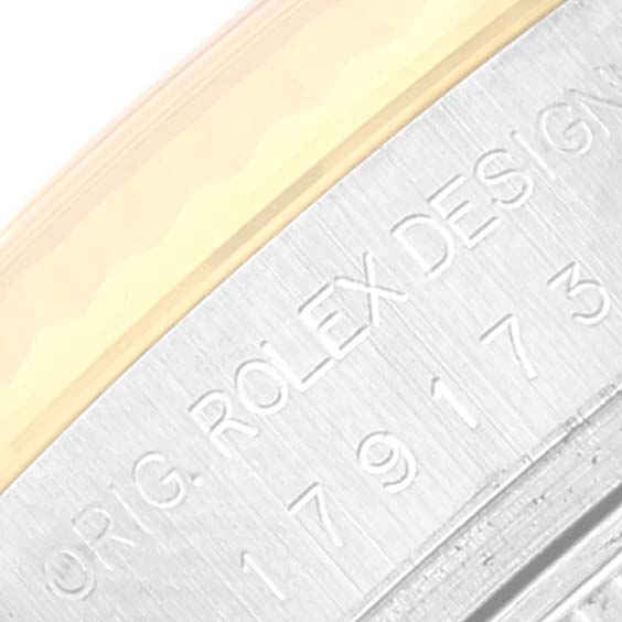 Close-up image of the casing edge and branding on a Rolex Datejust 179173 Women's Steel and Gold (two tone) Champagne Dial 179173 Women's Steel and Gold (two tone) Champagne Dial watch, highlighting the engraved text.