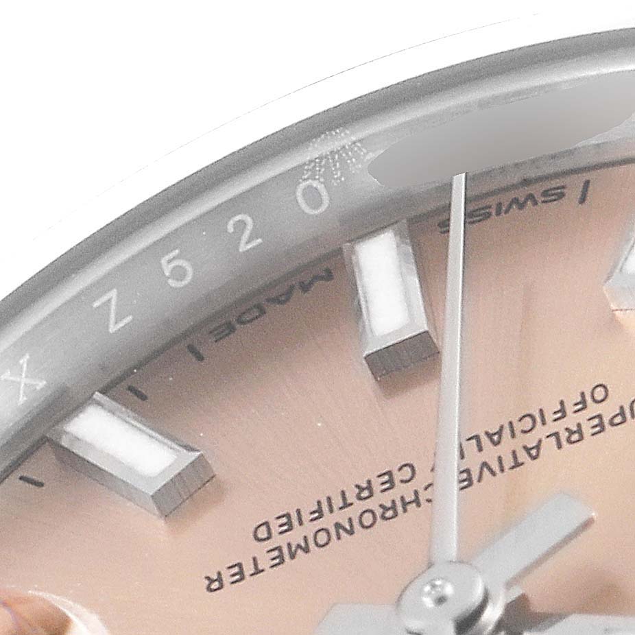 This close-up angle of the Rolex Datejust 279174 Women's Stainless Steel Pink Dial 279174 Women's Stainless Steel Pink Dial model shows the edge of the dial, index markers, and part of the hands.
