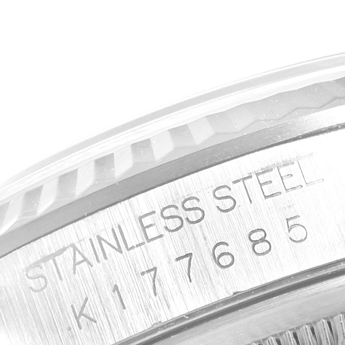 This image shows a close-up of the side of a Rolex Datejust 16234 Men's Stainless Steel White Dial 16234 Men's Stainless Steel White Dial watch with "STAINLESS STEEL" and the serial number engraved.