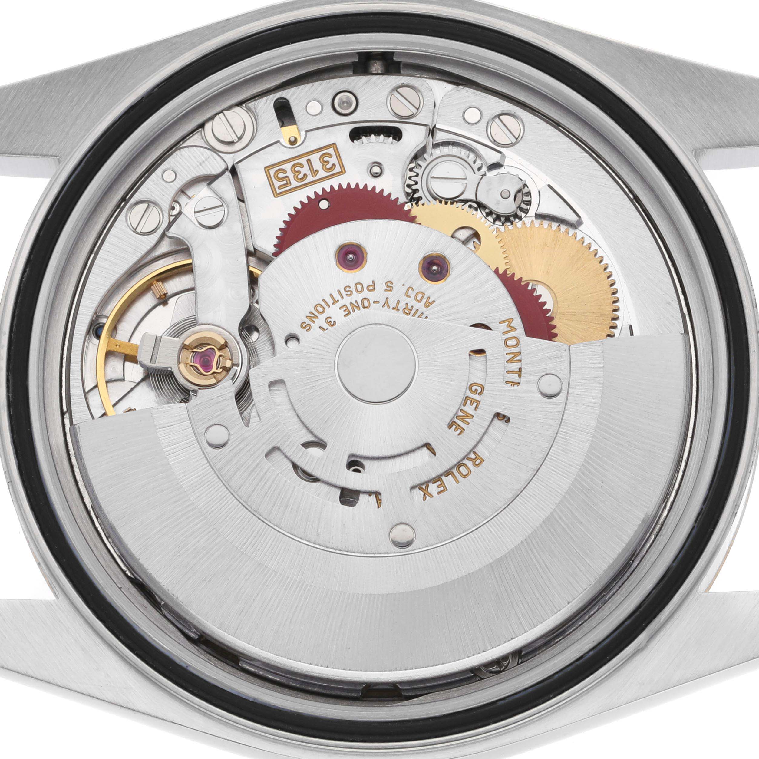 The image shows the movement of a Rolex Datejust 16233 Men's Steel and Gold (two tone) Champagne Dial watch from the back, highlighting gears and mechanisms.