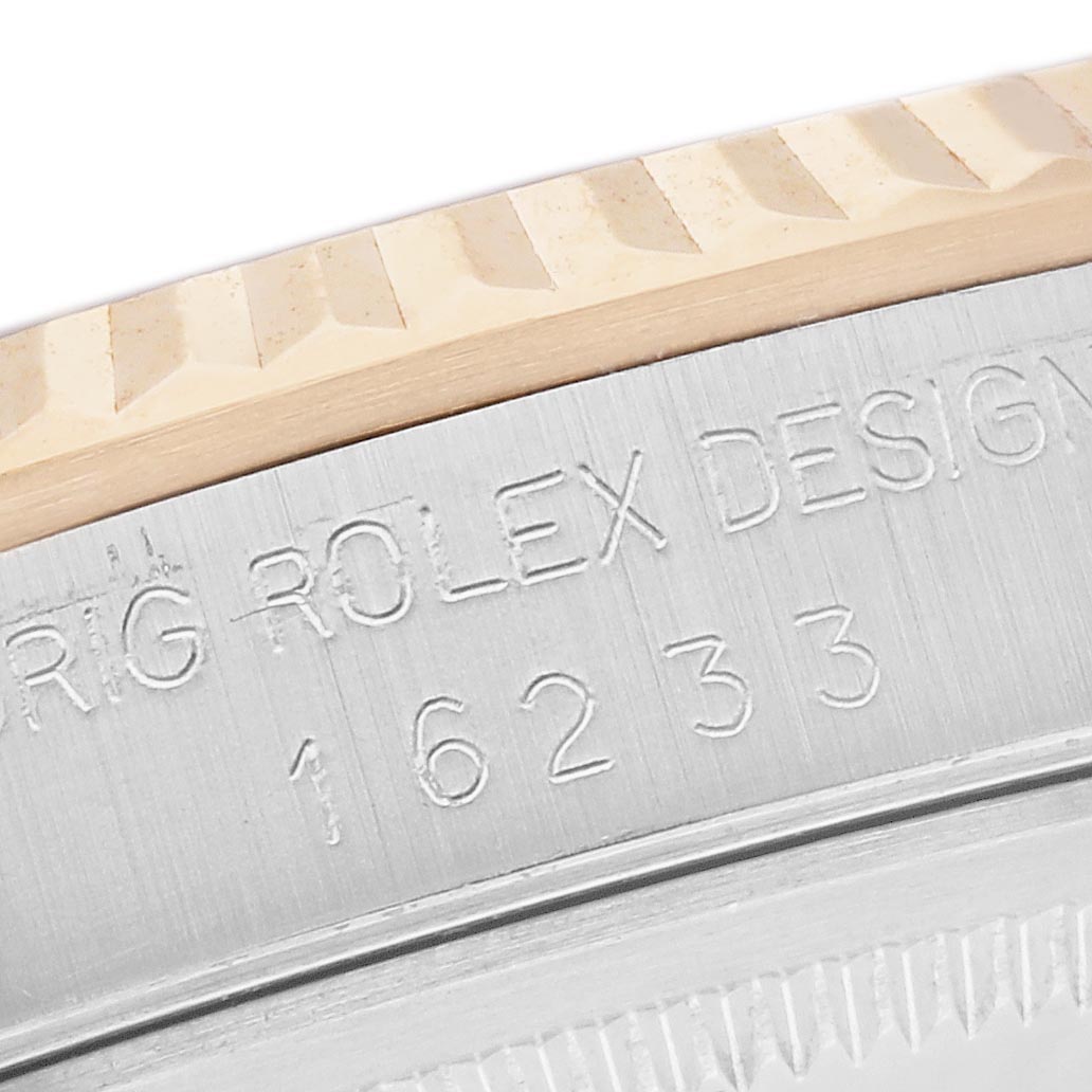 The image shows a close-up of the side engraving and fluted bezel of the Rolex Datejust 16233 Men
s Steel and Gold (two tone) Champagne Dial 16233 Men
s Steel and Gold (two tone) Champagne Dial watch, highlighting model details.