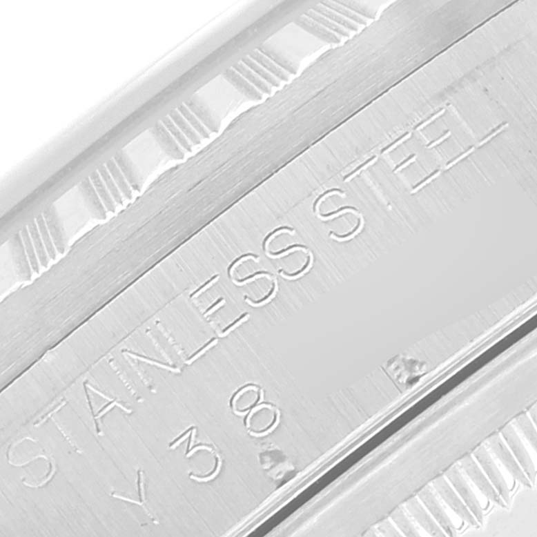 Close-up of the case edge of a Rolex Datejust 16220 Men's Stainless Steel Blue Dial 16220 Men's Stainless Steel Blue Dial, showing the stainless steel inscription and part of the fluted bezel.