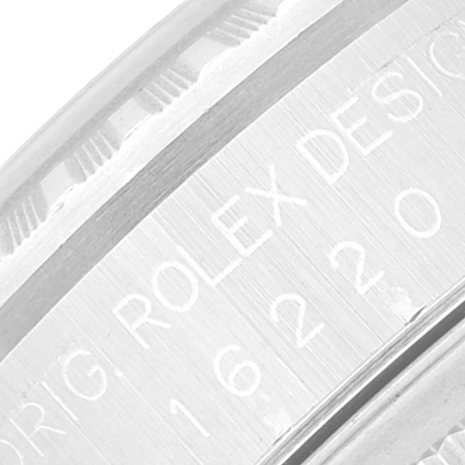 The image shows a close-up of the rehaut engraving and inner bezel of a Rolex Datejust 16220 Men's Stainless Steel Blue Dial 16220 Men's Stainless Steel Blue Dial watch.