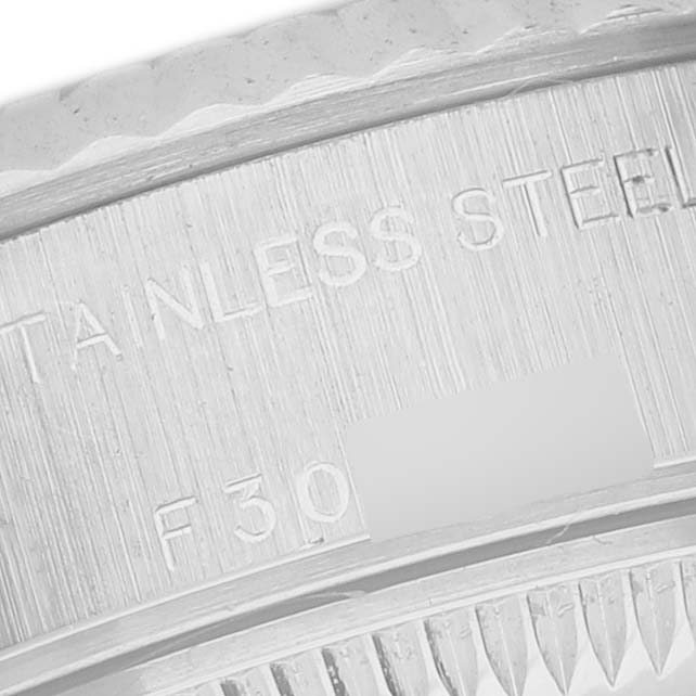 The image shows a close-up of the engraved inner bezel of a Rolex Datejust 79174 Women's Stainless Steel Mother of Pearl Dial, highlighting the stainless steel marking.