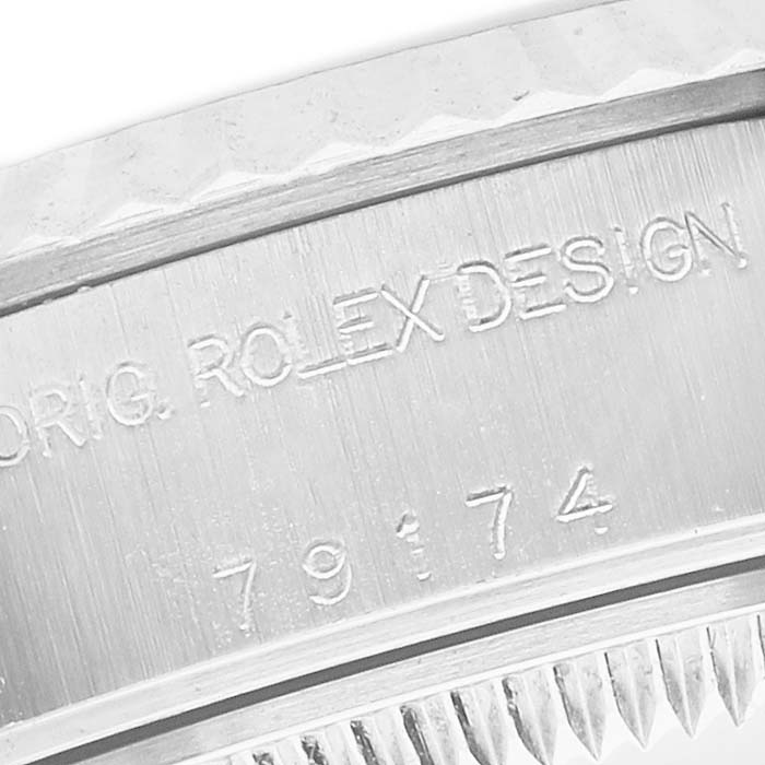 The image shows a close-up of the side of a Rolex Datejust 79174 Women's Stainless Steel Mother of Pearl Dial watch, highlighting the engraved "ORIG. ROLEX DESIGN" and model number.