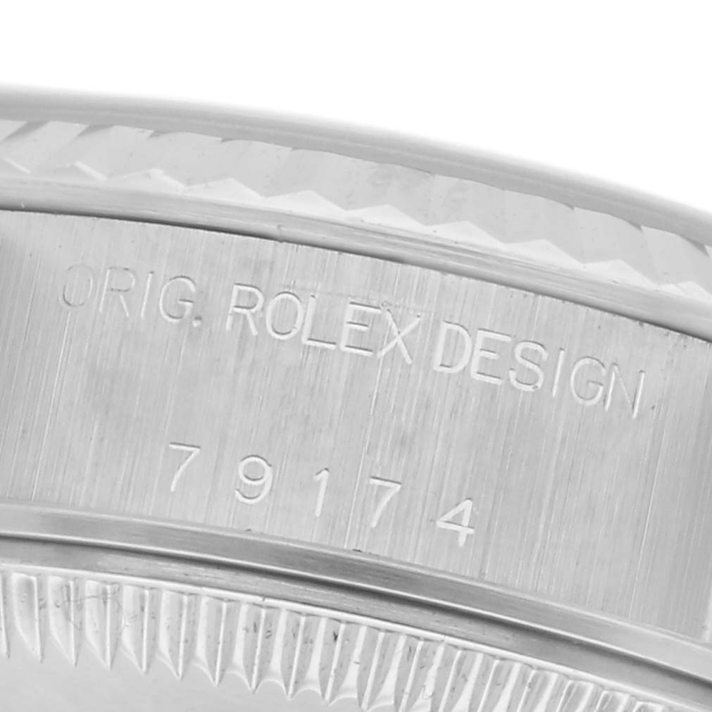 The image shows a close-up of the engraved side casing of a Rolex Datejust 79174 Women
s Stainless Steel Pink Dial 79174 Women
s Stainless Steel Pink Dial watch, featuring its model number.