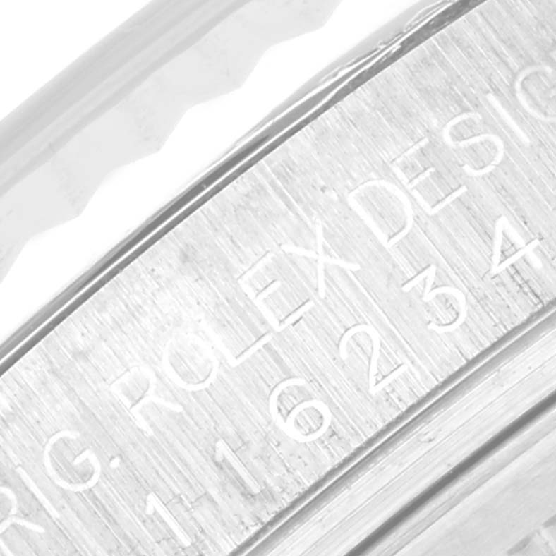 Close-up view of the engraved serial number on the case side of a Rolex Datejust 116234 Men's Stainless Steel Pink Dial 116234 Men's Stainless Steel Pink Dial watch.