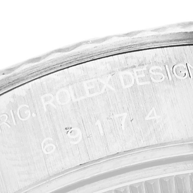 The image shows a close-up of the engraved serial number on the case of a Rolex Datejust 69174 Women's Stainless Steel Silver Dial 69174 Women's Stainless Steel Silver Dial watch.