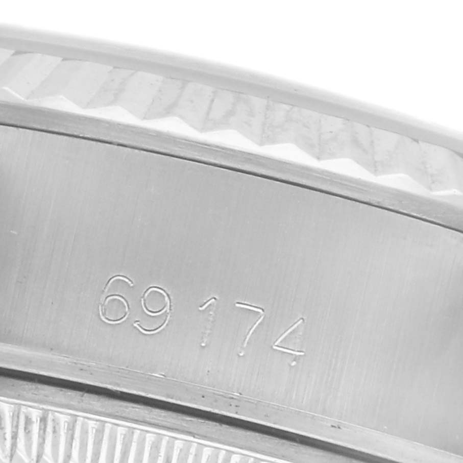 The image shows a close-up of the Rolex Datejust 69174 Women
s Stainless Steel Silver Dial 69174 Women
s Stainless Steel Silver Dial watch, focusing on the side with model number "69174" etched.
