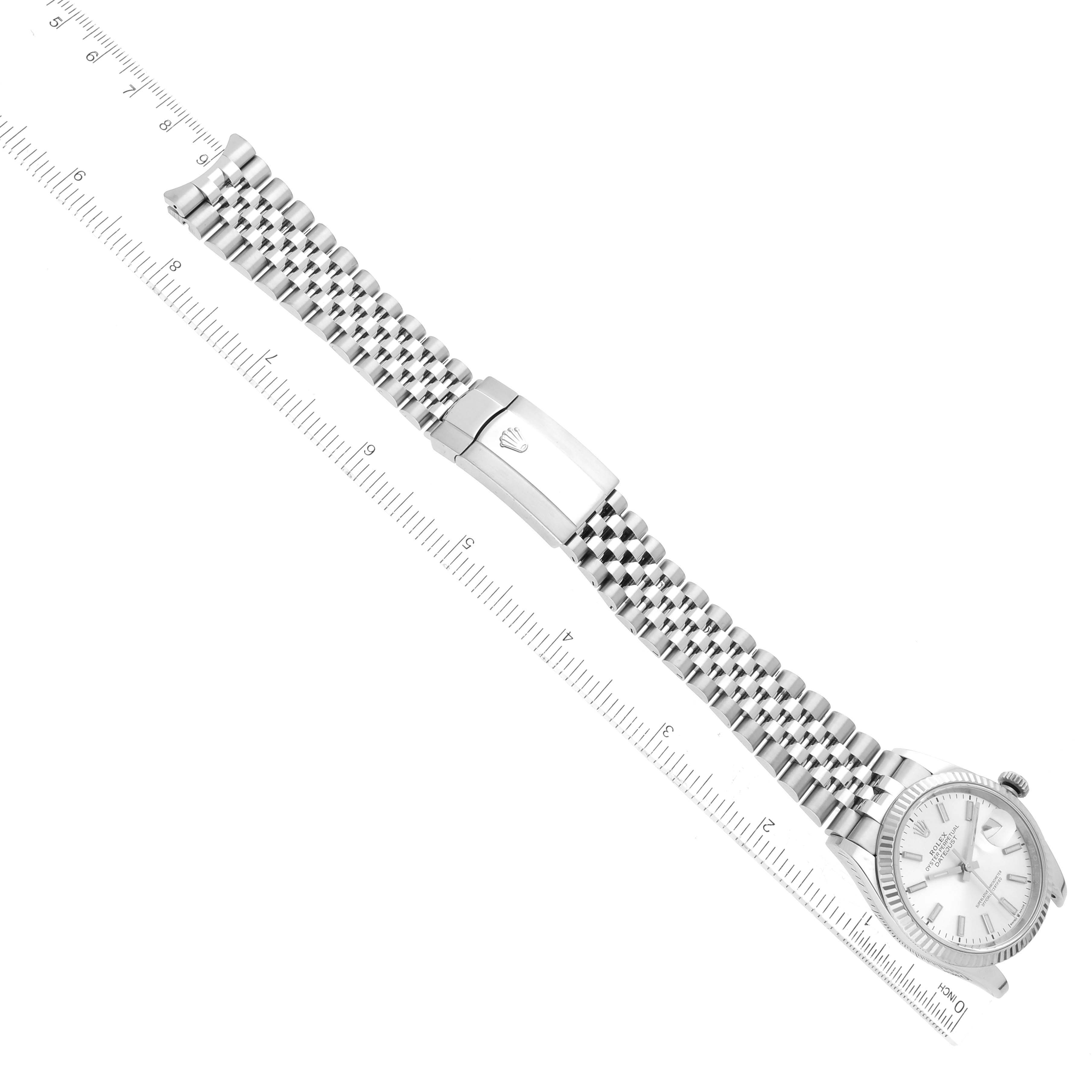 The image shows a Rolex Datejust 126234 Men's Stainless Steel Silver Dial 126234 Men's Stainless Steel Silver Dial watch from a top view, displaying its face, bracelet, and clasp alongside a ruler.