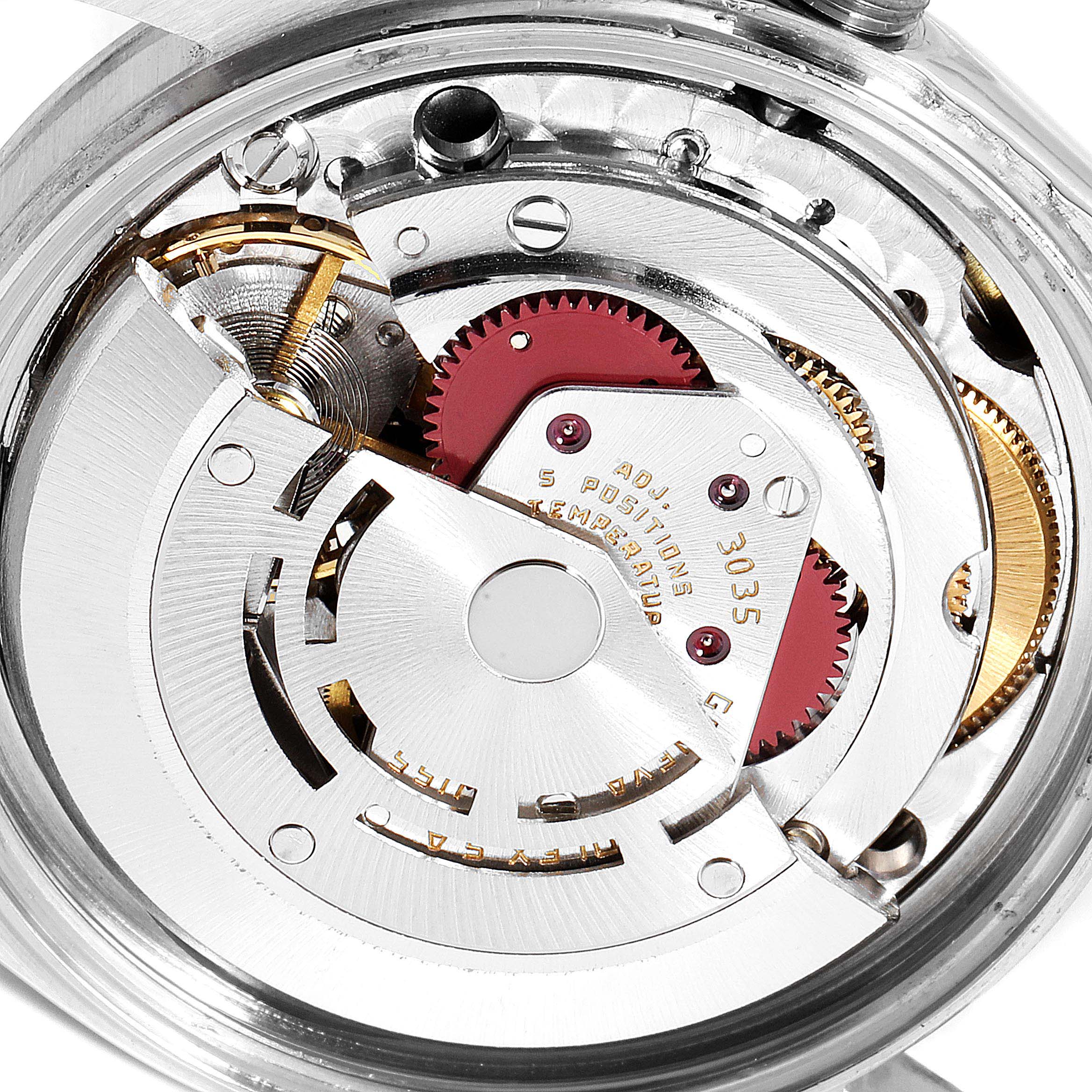 This image shows a close-up view of the movement inside a Vintage Collection Rolex watch, highlighting the intricate gears and mechanisms.