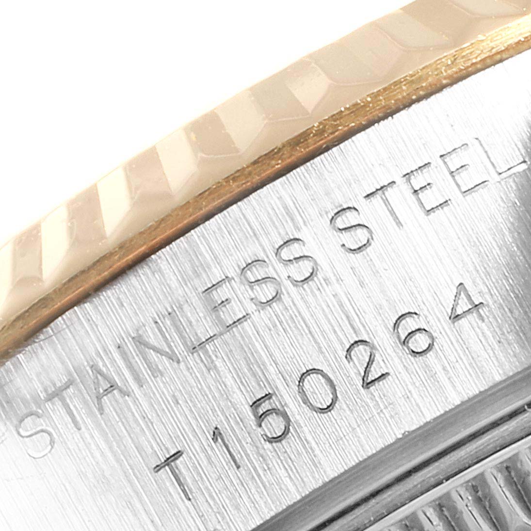 The image shows a close-up of the side of a Rolex Datejust 69173 Women
s Steel and Gold (two tone) Beige Dial 69173 Women
s Steel and Gold (two tone) Beige Dial watch, highlighting the fluted bezel and the stainless steel engraving.