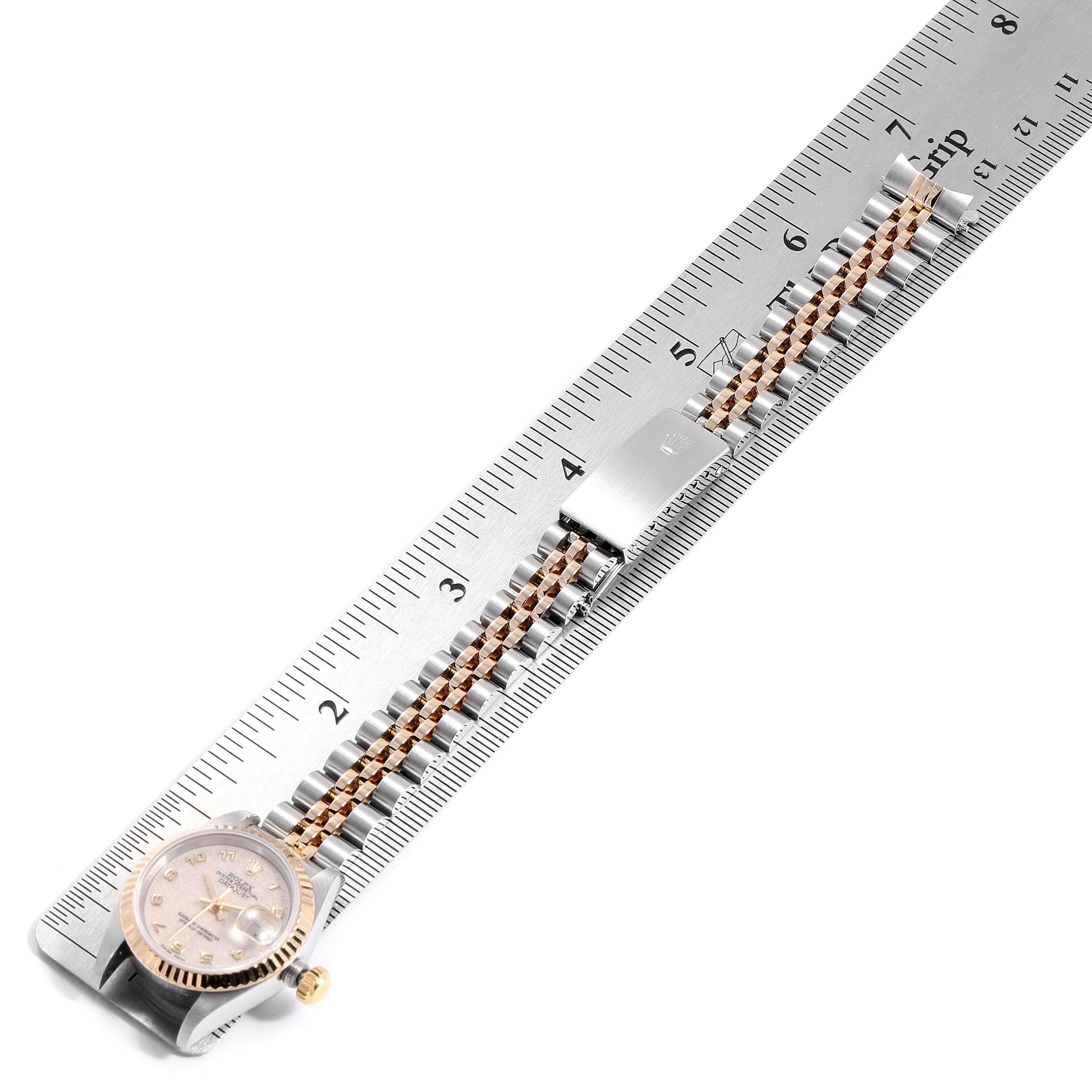 The Rolex Datejust 69173 Women
s Steel and Gold (two tone) Beige Dial 69173 Women
s Steel and Gold (two tone) Beige Dial watch is shown from above alongside a ruler, highlighting the face, bezel, crown, and bracelet.