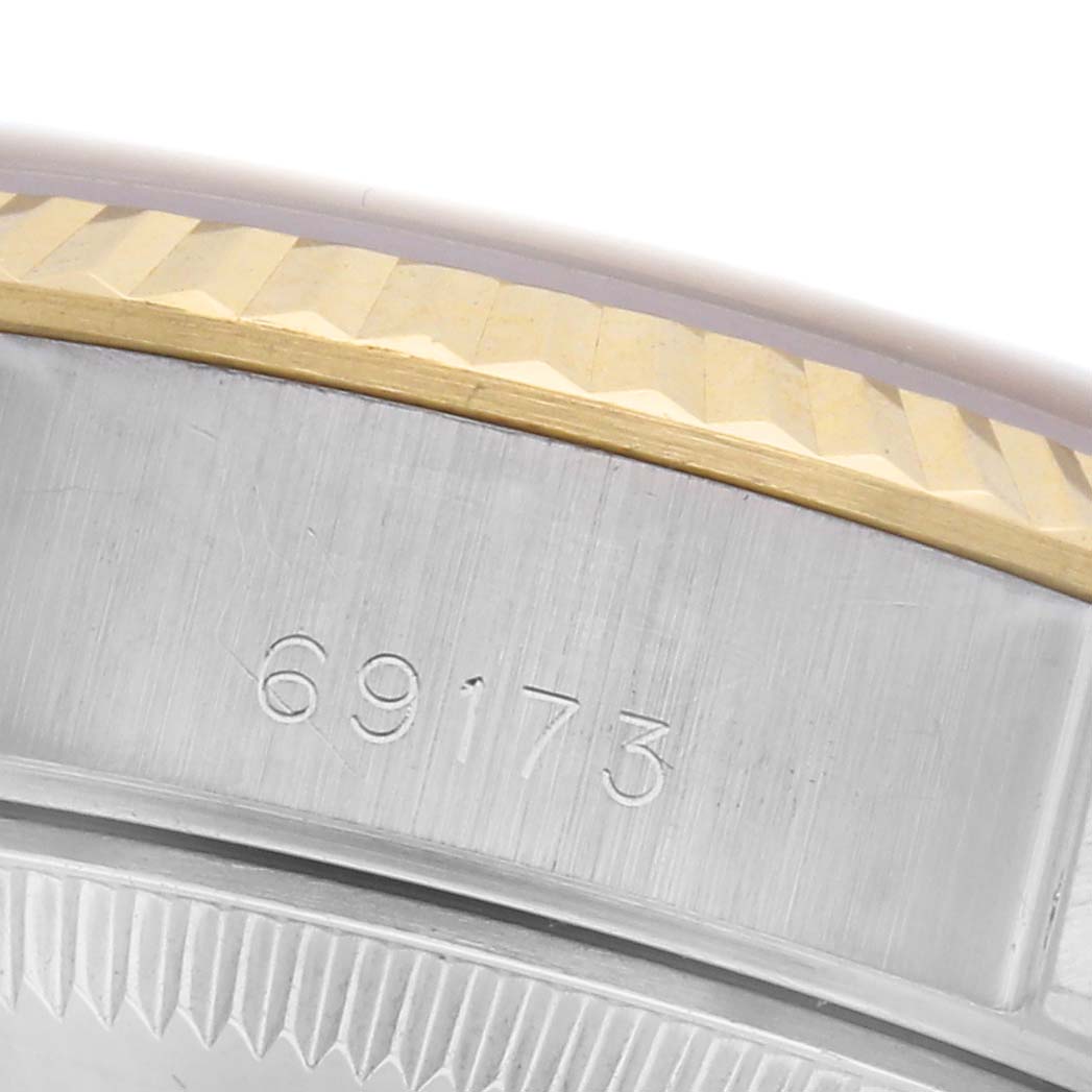The image shows a close-up of the Rolex Datejust 69173 Women
s Steel and Gold (two tone) Champagne Dial 69173 Women
s Steel and Gold (two tone) Champagne Dial model
s case, highlighting the bezel and model number.