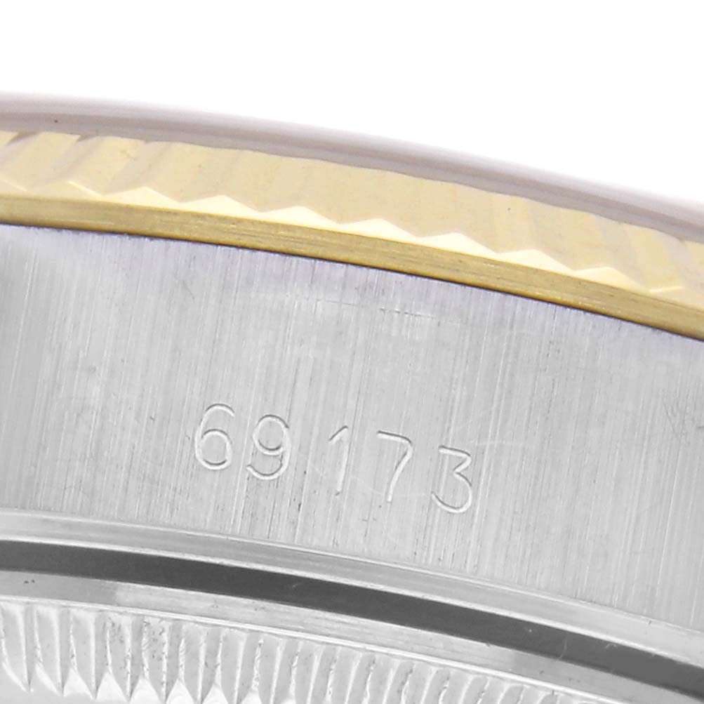 The image shows a close-up of the side bezel and part of the case of a Rolex Datejust 69173 Women
s Steel and Gold (two tone) Champagne Dial 69173 Women
s Steel and Gold (two tone) Champagne Dial, featuring a gold and steel combination.